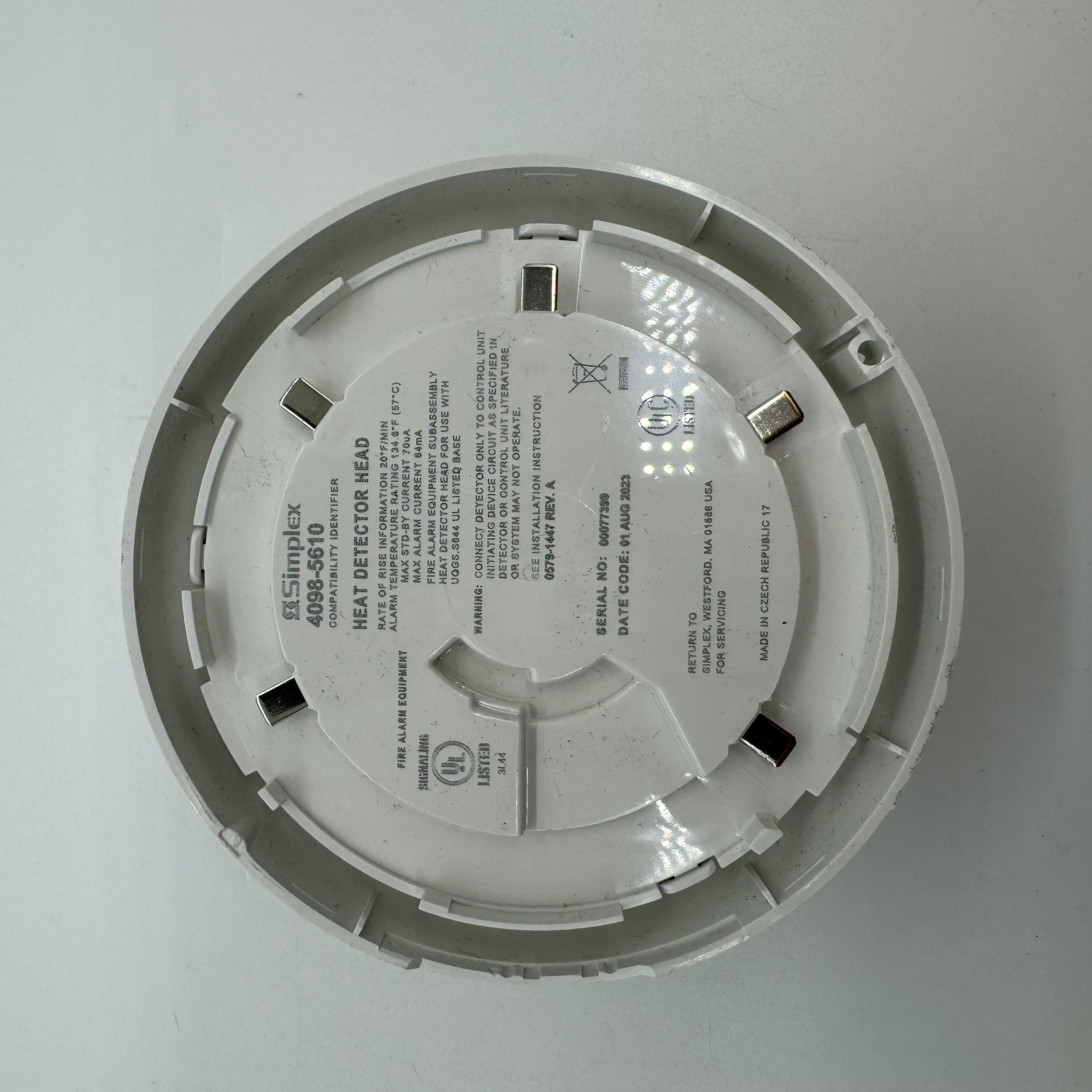 Simplex 4098-5610 heat detector showing a compact, white sensor unit used for fire safety in commercial systems