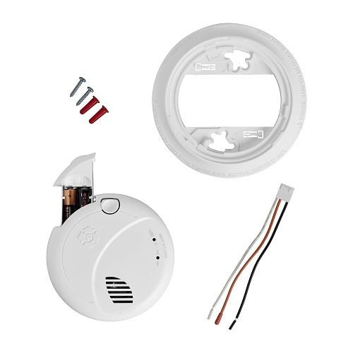BRK SMCO100V-AC smoke and carbon monoxide alarm with voice alerts, mounted on wall, showing digital display and test button.