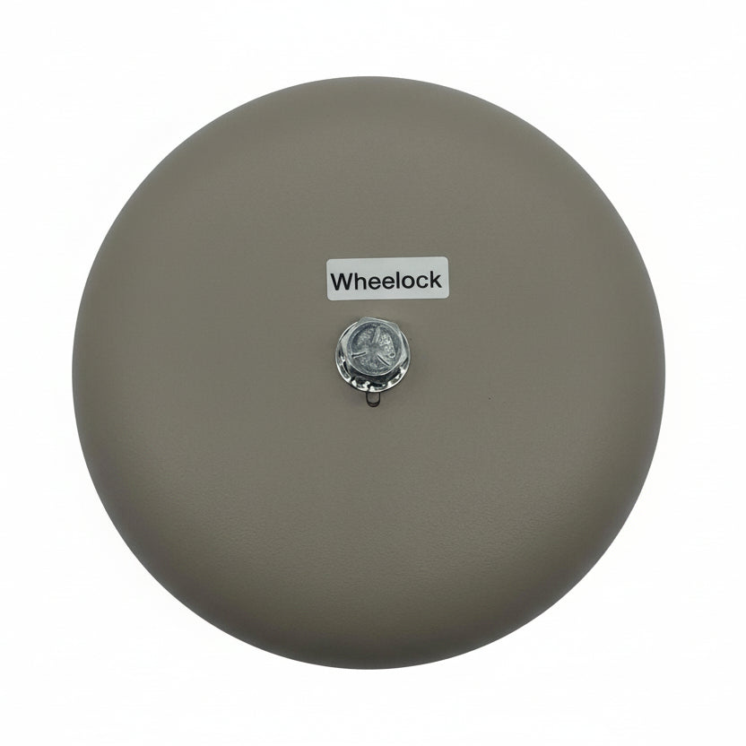 Eaton Wheelock 43T-G6-115-S bell, metal with a black finish, mounted on a wall with wiring visible, designed for security or alert systems.