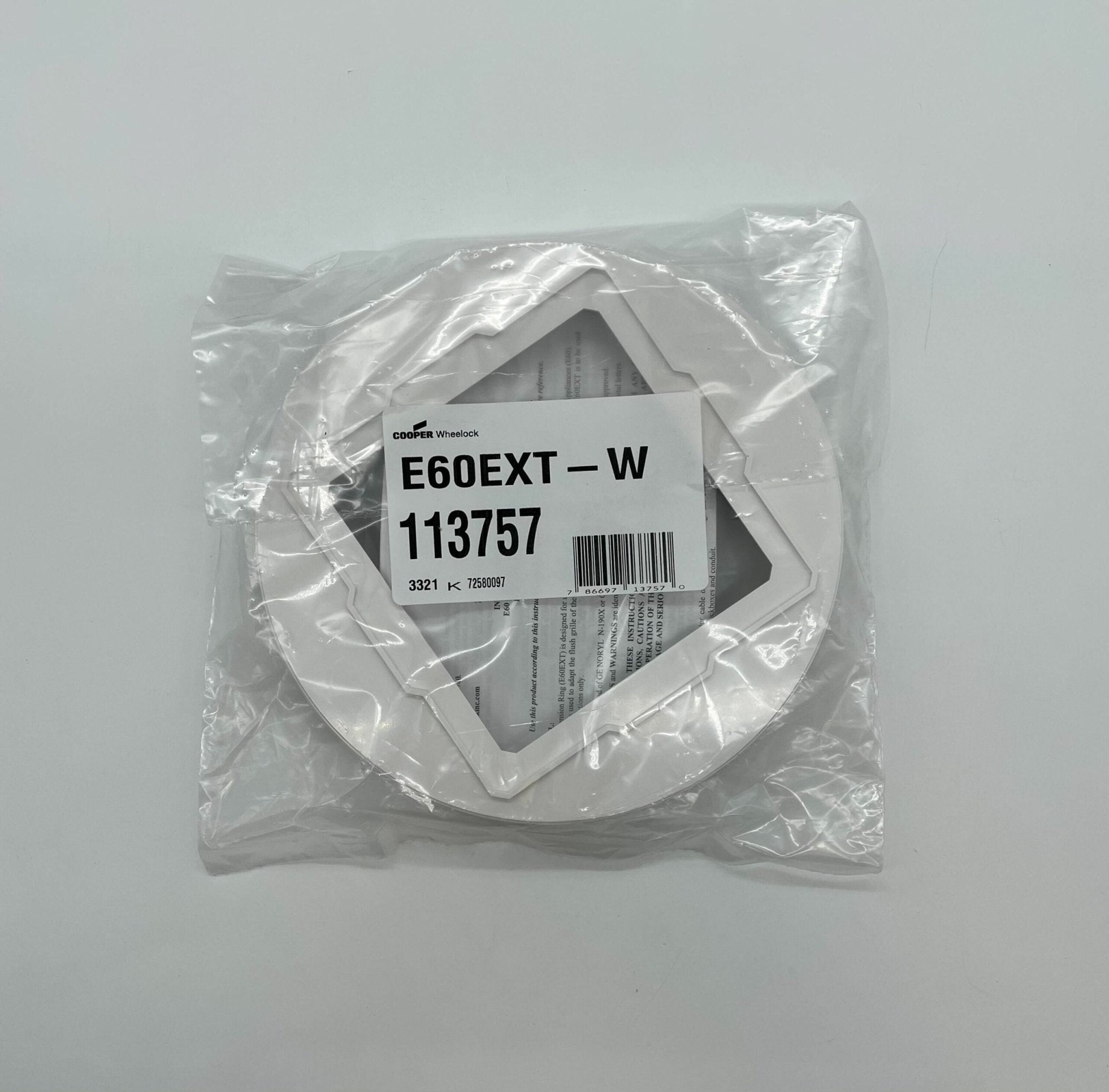 Eaton Wheelock E60EXT-W fire alarm with speaker and strobe light, mounted on a ceiling for emergency alerting.