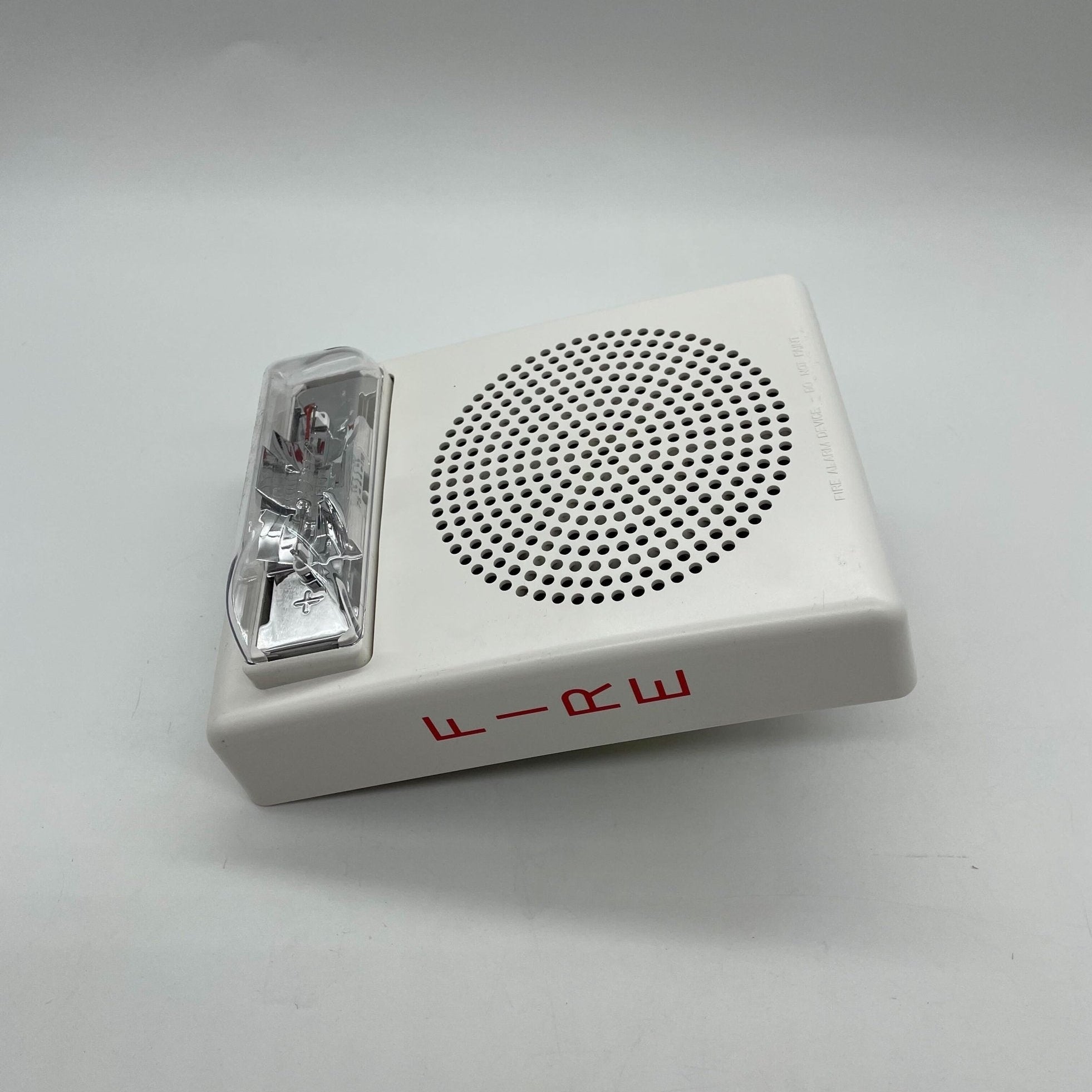 Eaton Wheelock E50H-24MCW-FW speaker strobe light with white housing, visible mounting hardware in the image.