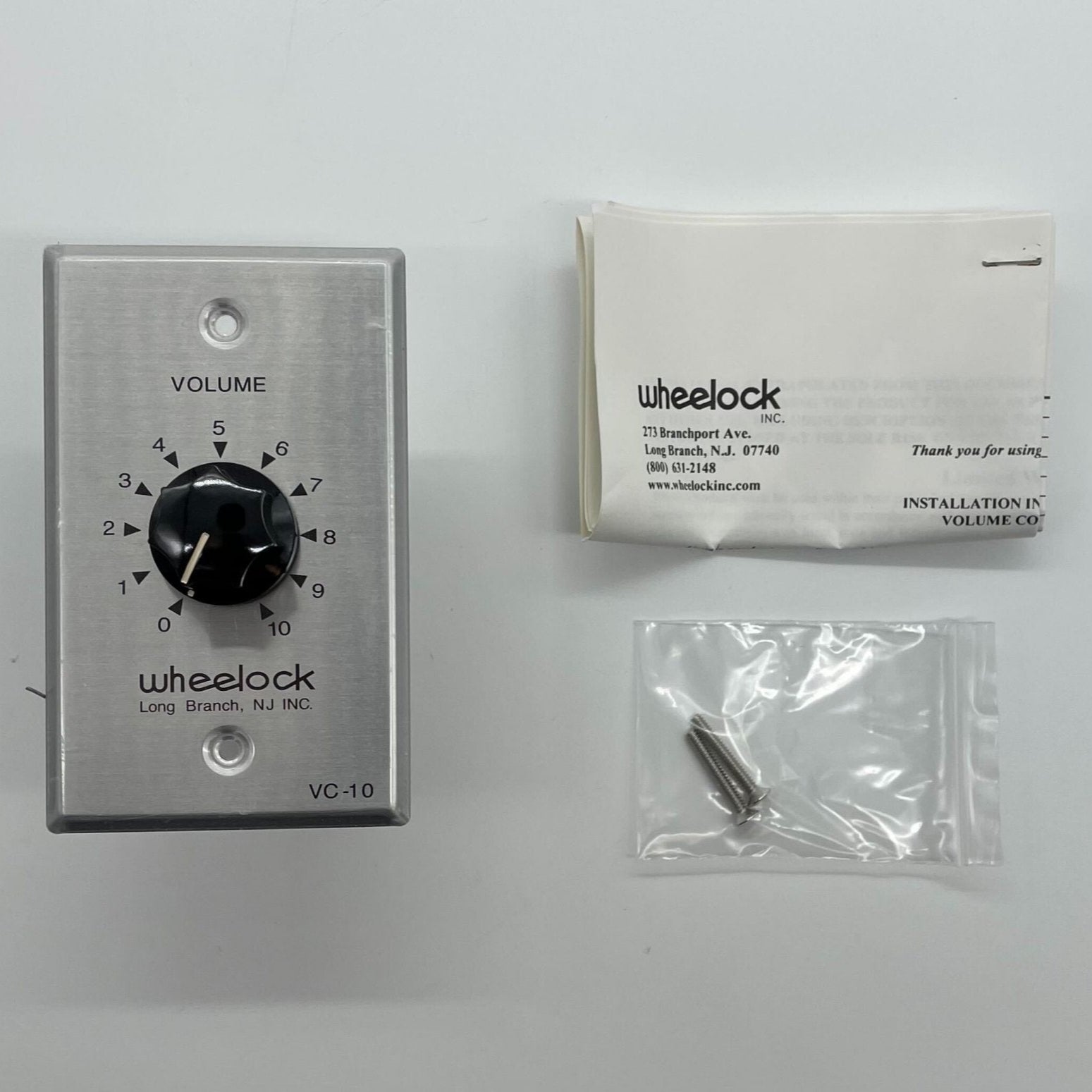 Eaton Wheelock VC-10 fire alarm horn/strobe with red housing and mounting bracket for emergency alert systems.