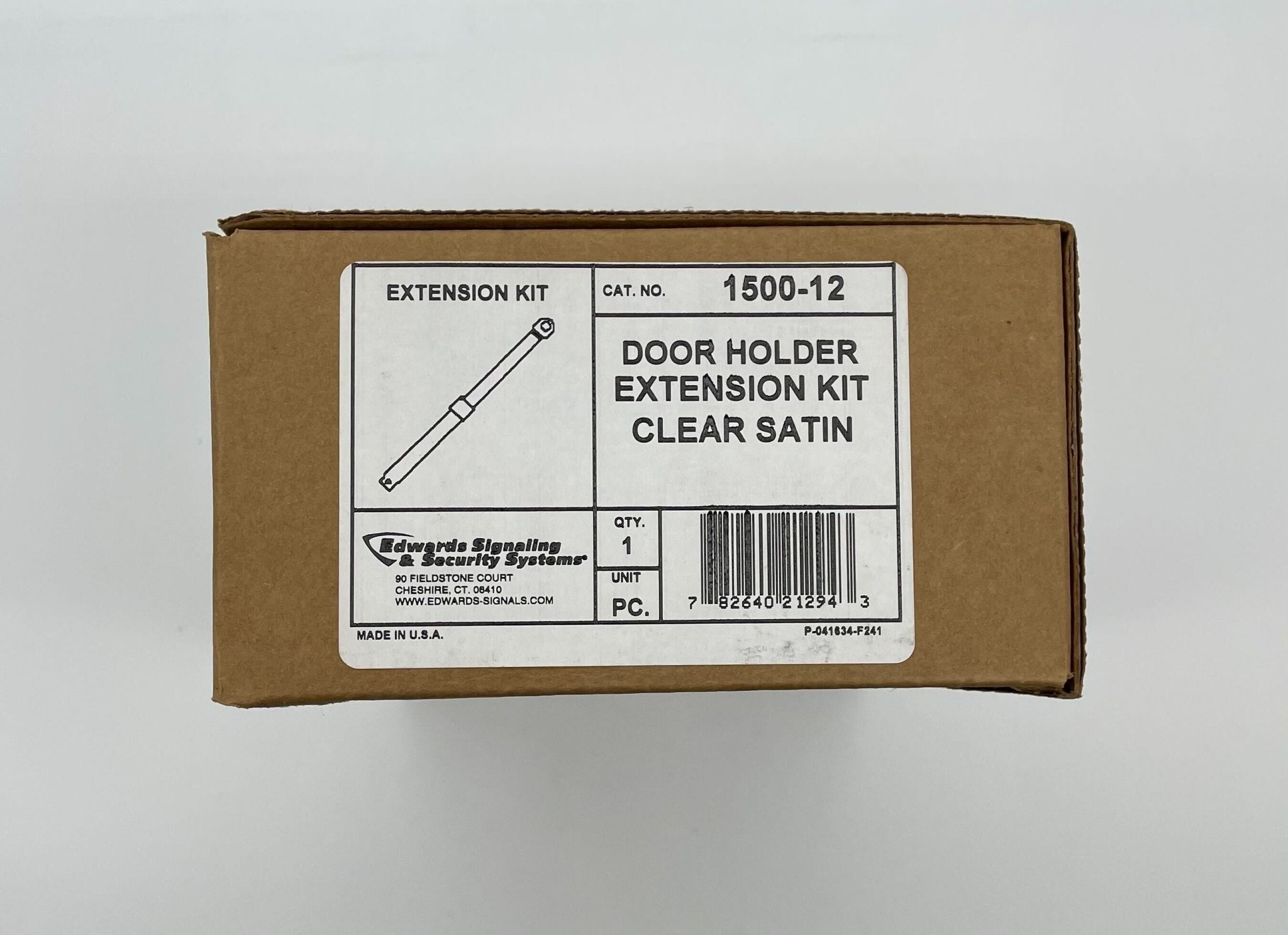 Edwards 1500-12 door holder mounted on a door, showing its sturdy metal construction and wall mounting plate.