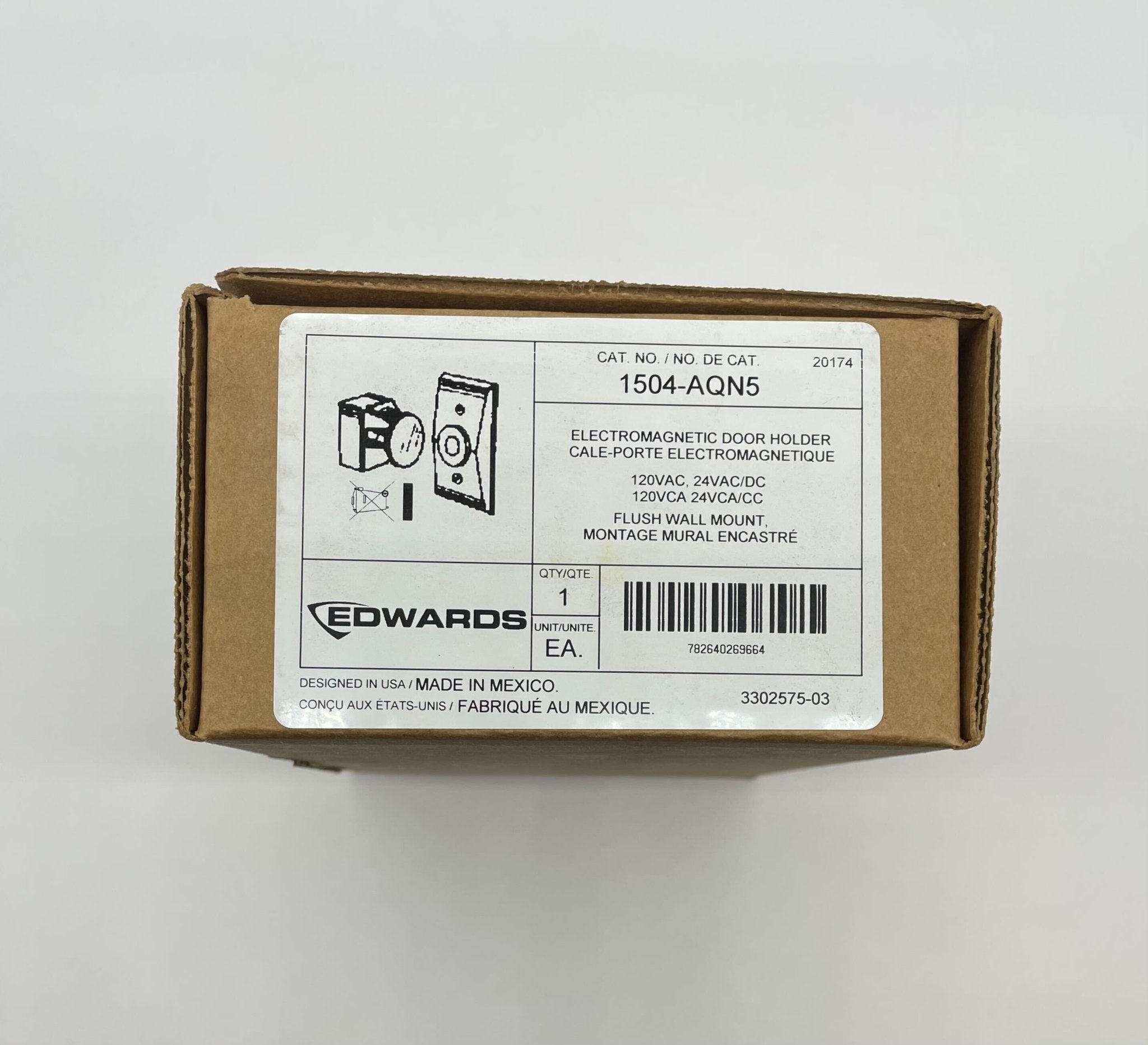 Edwards 1504-AQN5 door holder mounted on a door, showing its metal construction and wall bracket for secure door hold open.