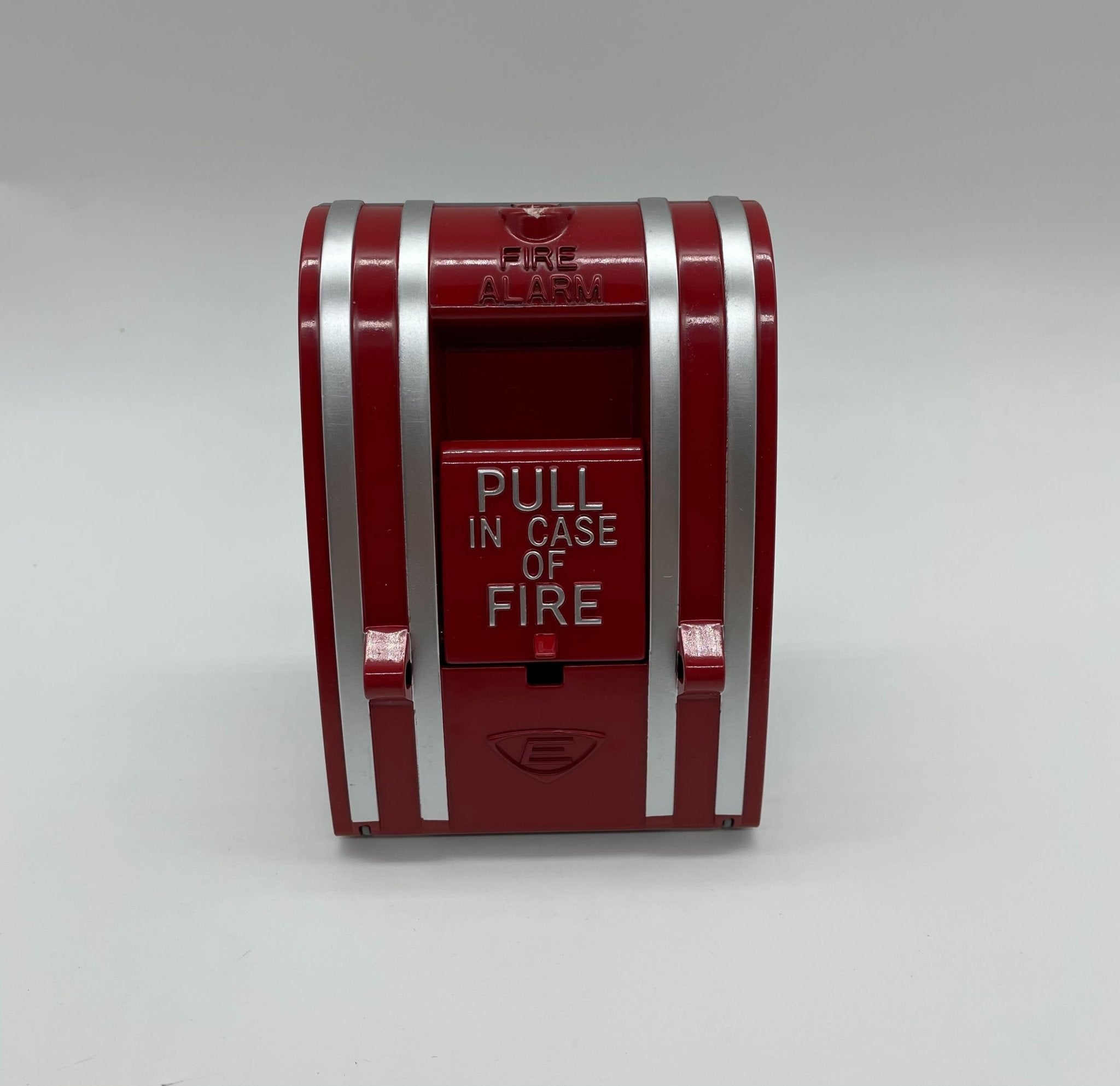 Edwards 270-DPO pull station fire alarm device mounted on wall, black metal with red label and manual pull handle.