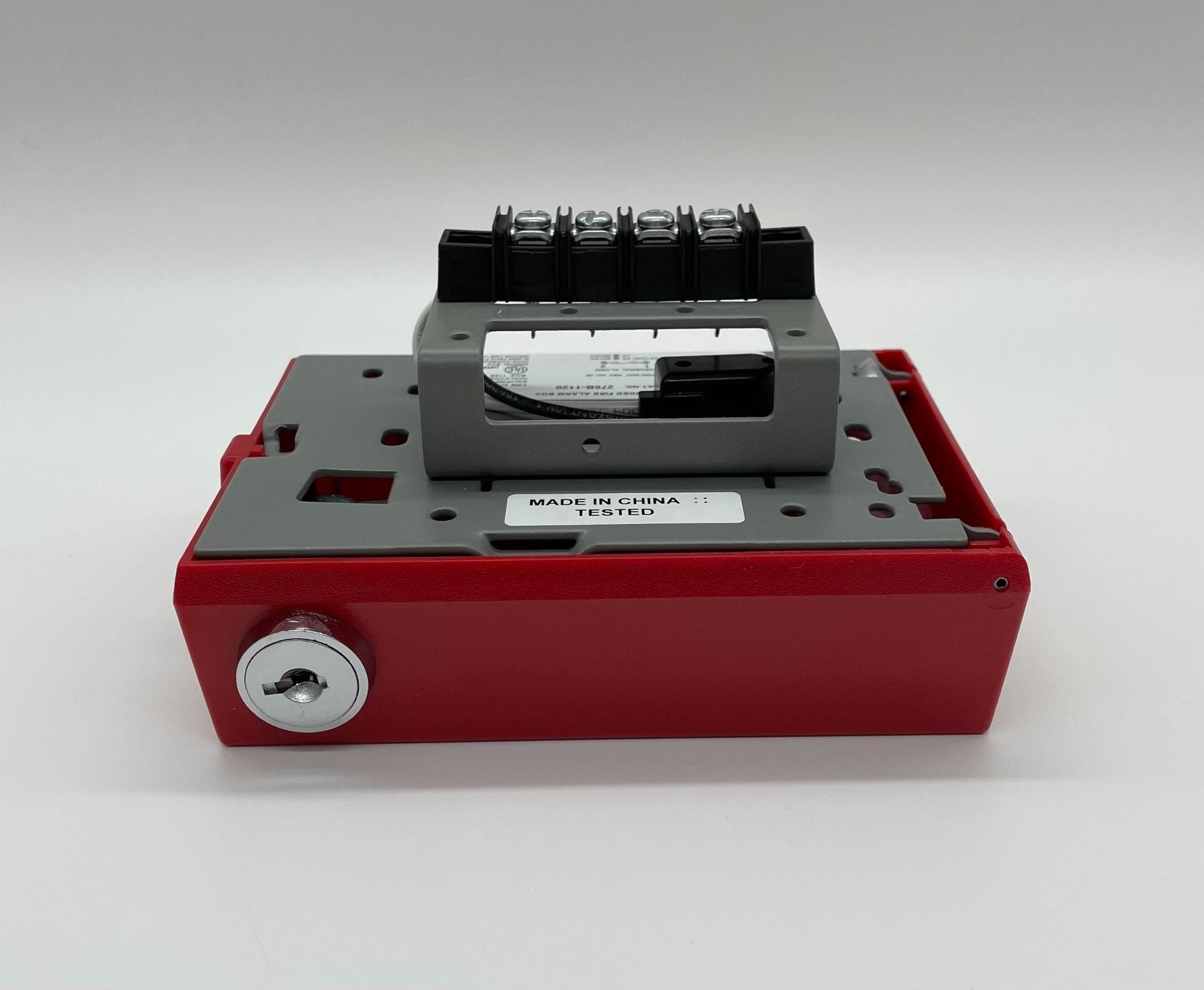 Edwards 276B-1120 pull station mounted on wall, emergency fire alarm switch with push button and label, black and red colors