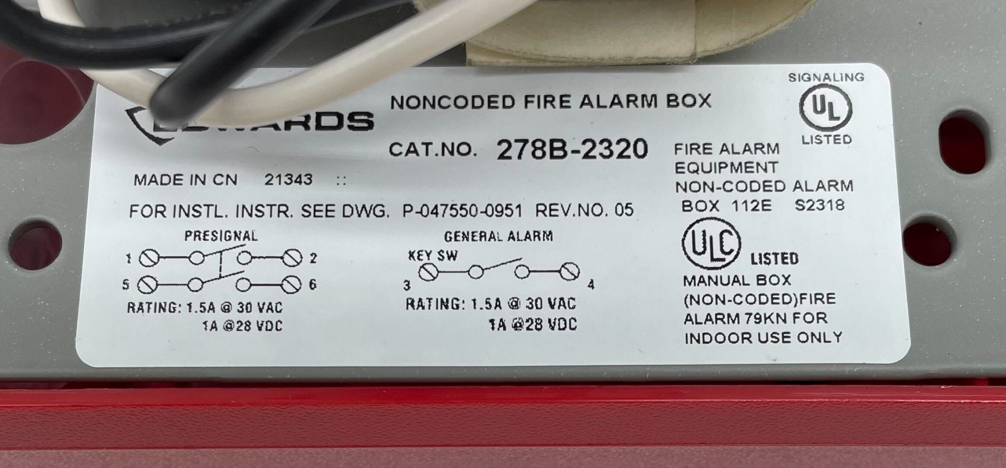 Edwards 278B-2320 pull station fire alarm device mounted on wall with clear label and metal casing.