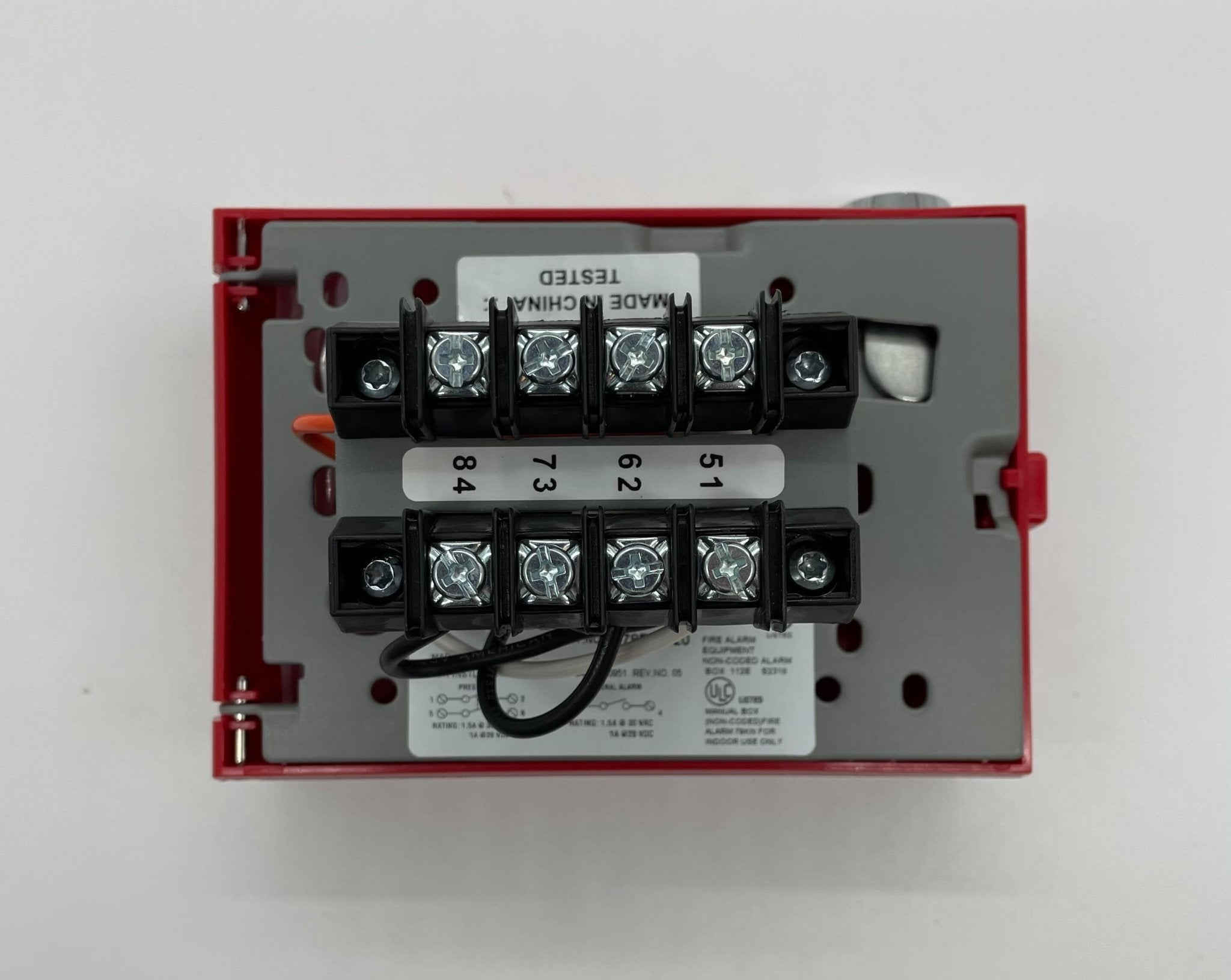 Edwards 278B-2320 pull station fire alarm device mounted on wall, with clear label and red alert button, by Edwards.