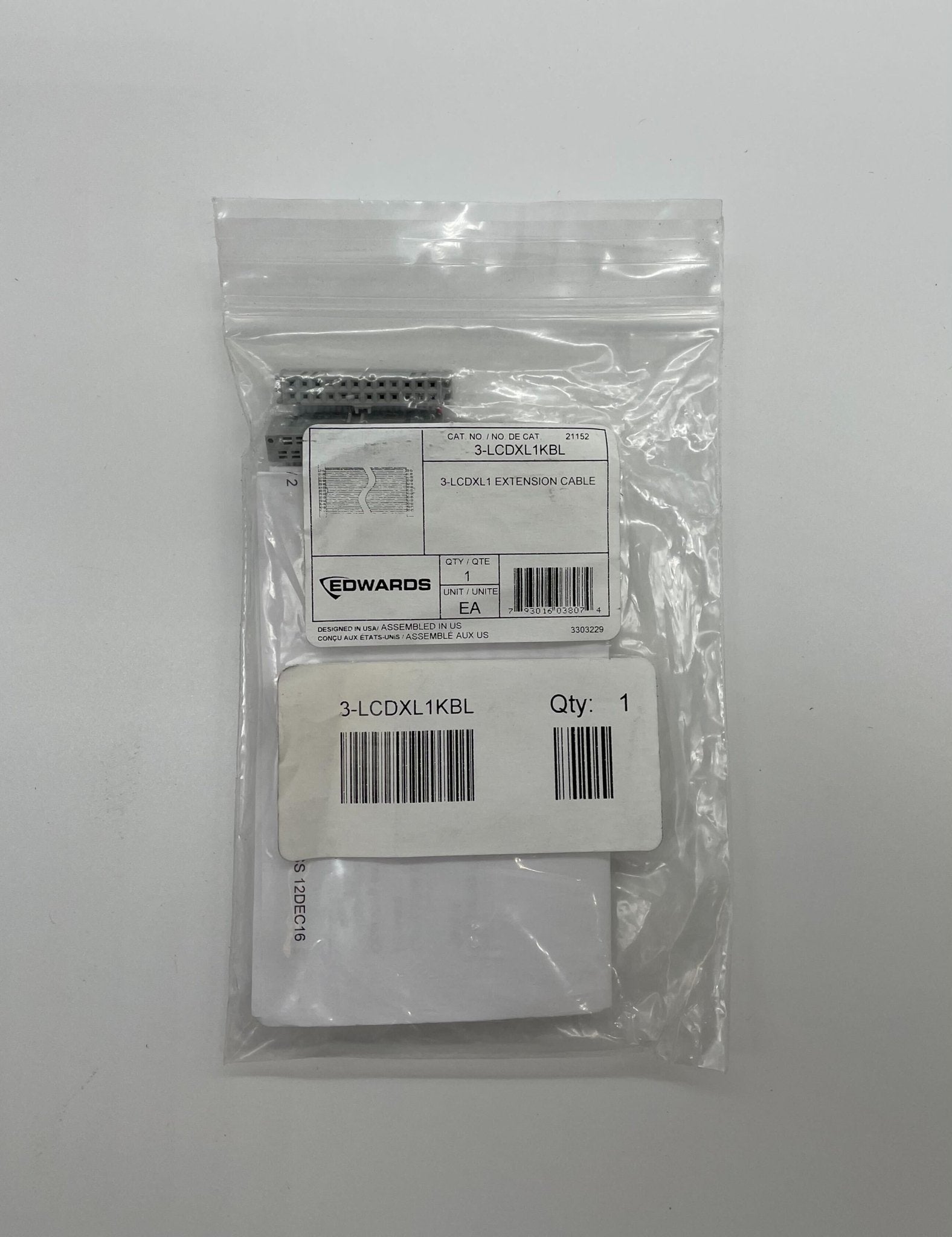 Edwards 3-LCDXL1KBL fire alarm with digital display, mounted on wall, in a commercial building setting.