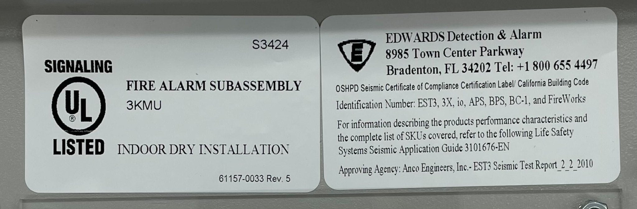 Edwards 3-RLCM/D fire alarm with red casing and digital display, mounted on a ceiling, designed for fire detection and alarm systems.