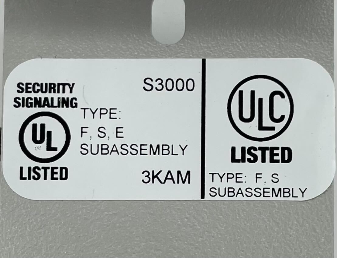 Edwards 3-TAMPRCC fire alarm sensor with red indicator light and wiring terminals, mounted on a wall.