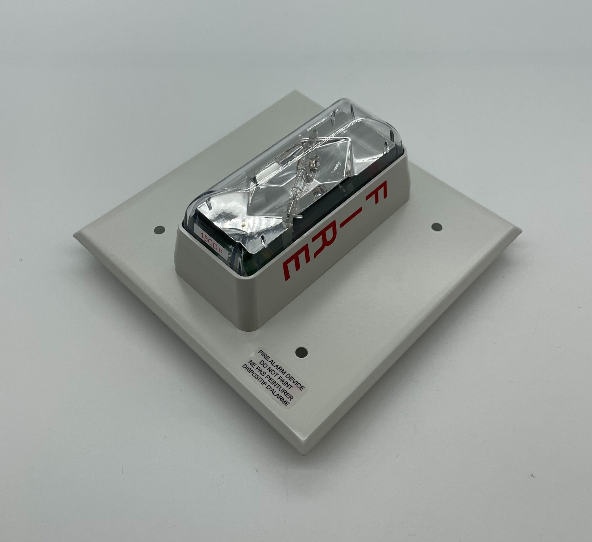 Edwards 405-5A-TW strobe light mounted on a ceiling with a rugged metal casing and visible wiring.