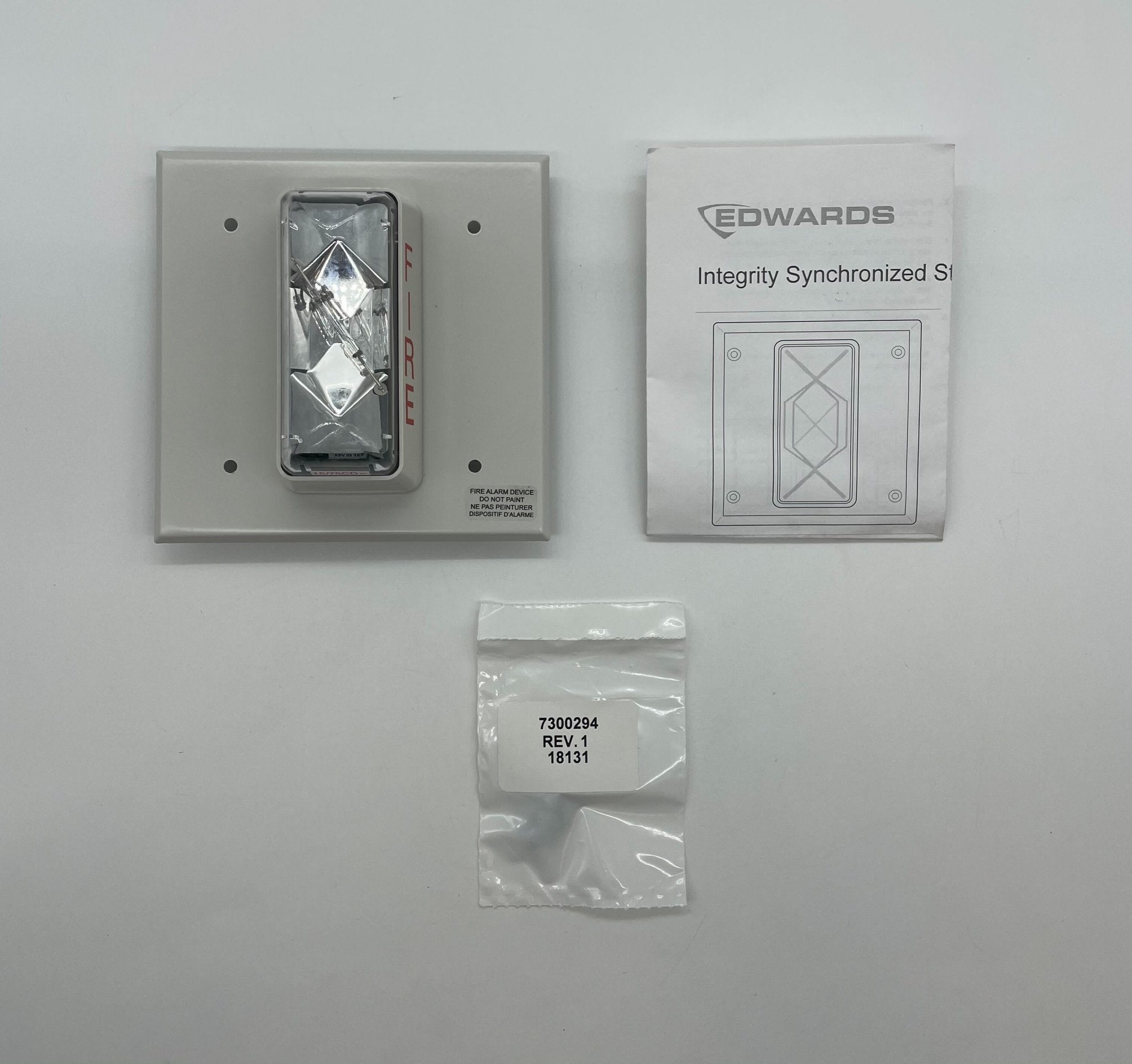 Edwards 405-7A-TW strobe light with blue lens, mounted on a fixture, used for industrial warning and signaling applications.
