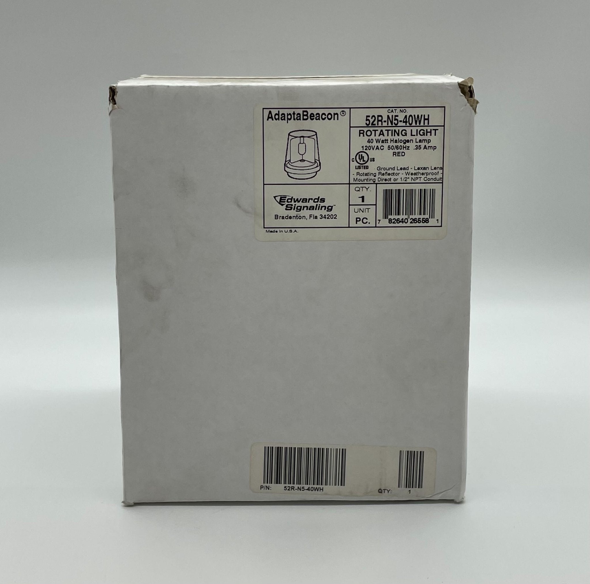 Edwards 52R-N5-40WH beacon with white housing and clear lens, mounted on a metal base for industrial signaling.