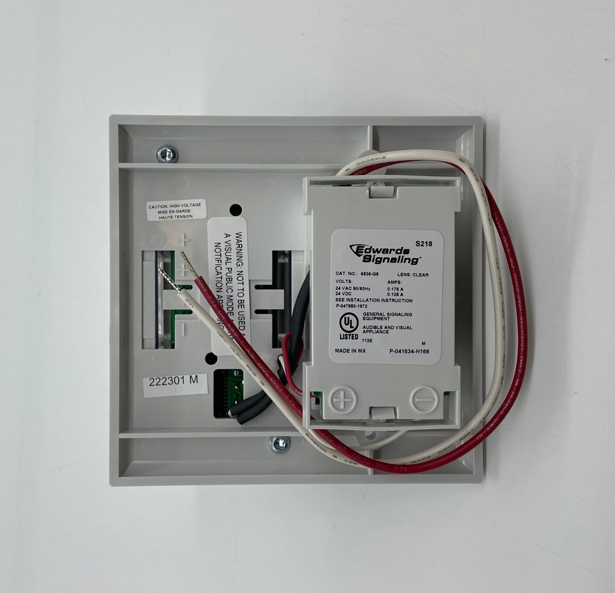 Edwards 7005-G5 fire alarm with digital display and alarm indicators, mounted on a wall.