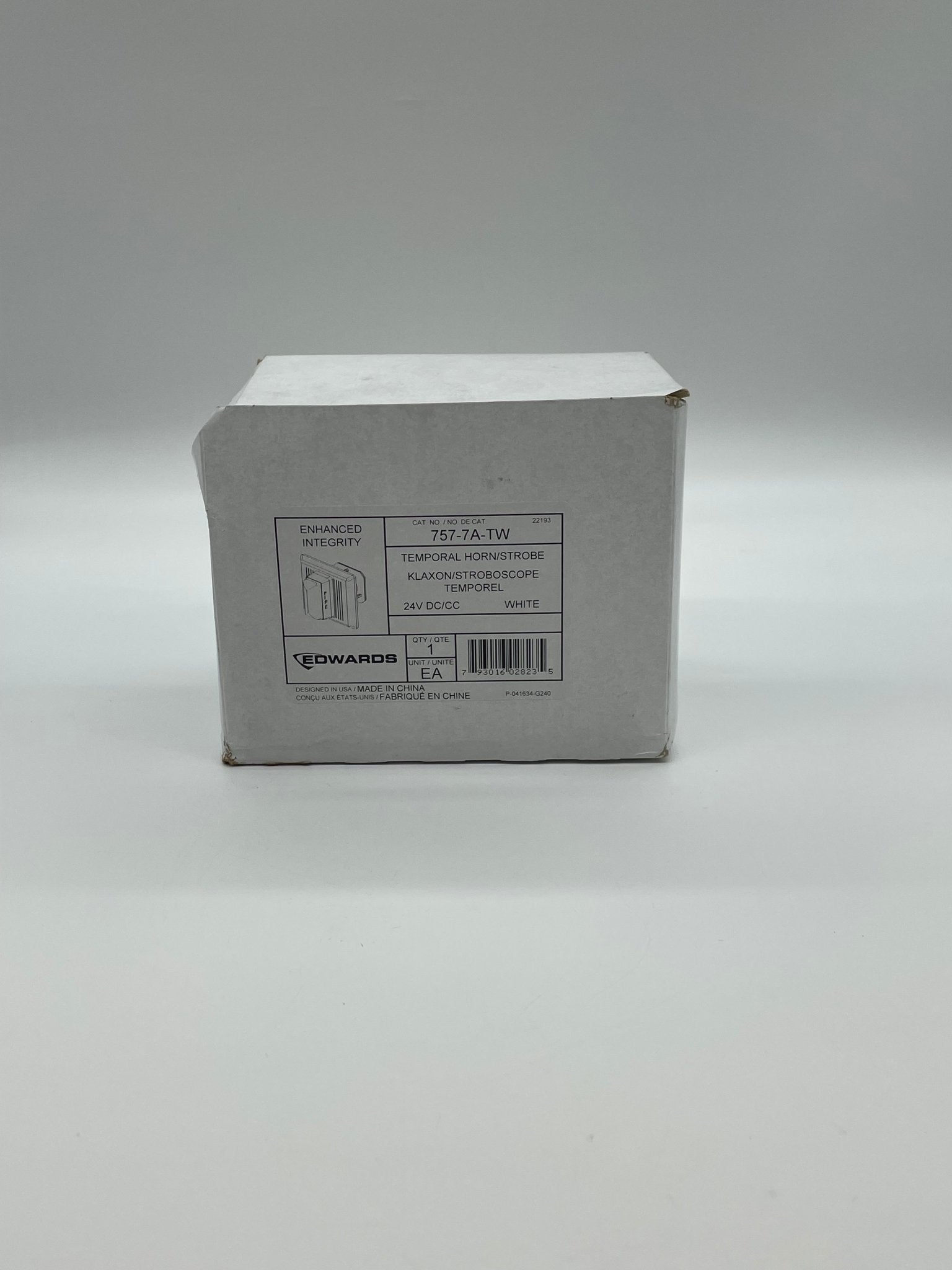 Edwards 757-7A-TW horn strobe with red housing and mounting brackets, designed for alarm notification systems.