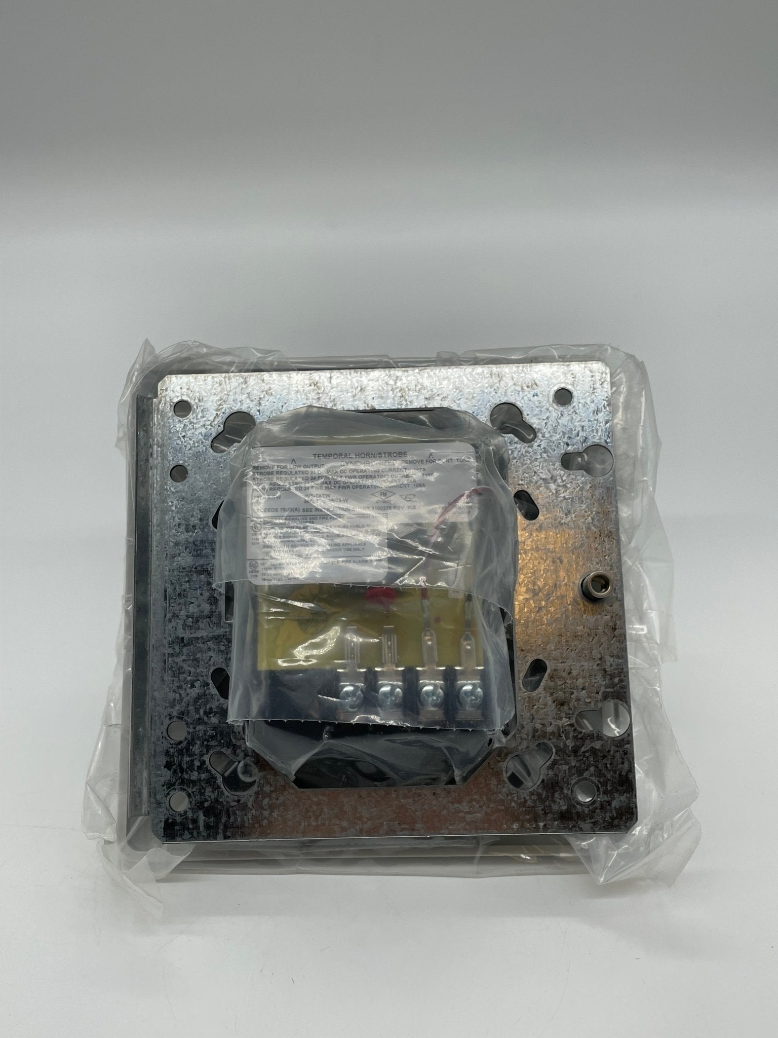 Edwards 757-7A-TW horn strobe alarm device with red housing and mounting bracket, designed for fire safety and emergency signaling.