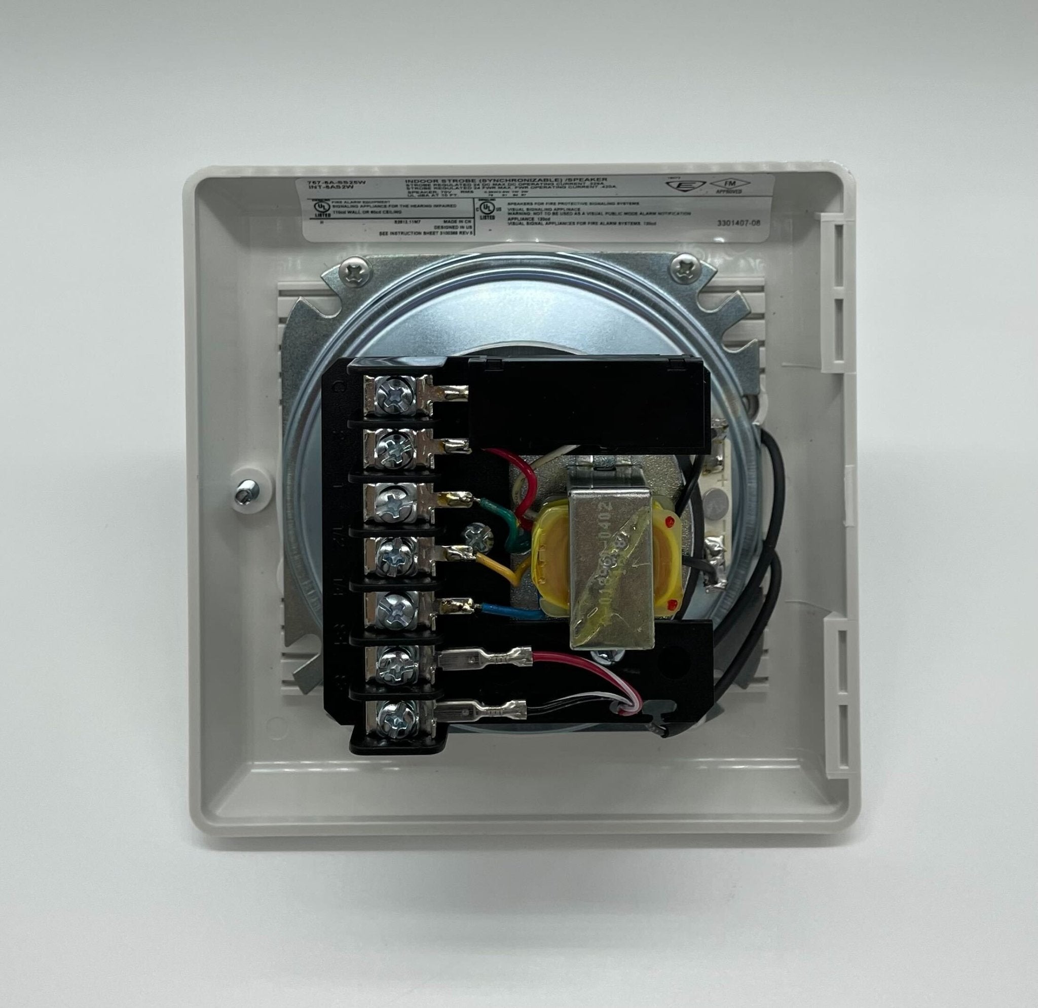 Edwards 757-8A-SS25W speaker strobe alarm in white, mounted on wall, with clear lens and wiring for fire safety alert system.