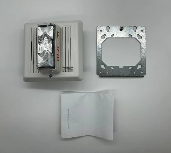 Edwards 757-8A-TW horn strobe alarm device mounted on a ceiling, with visible wiring and mounting bracket.