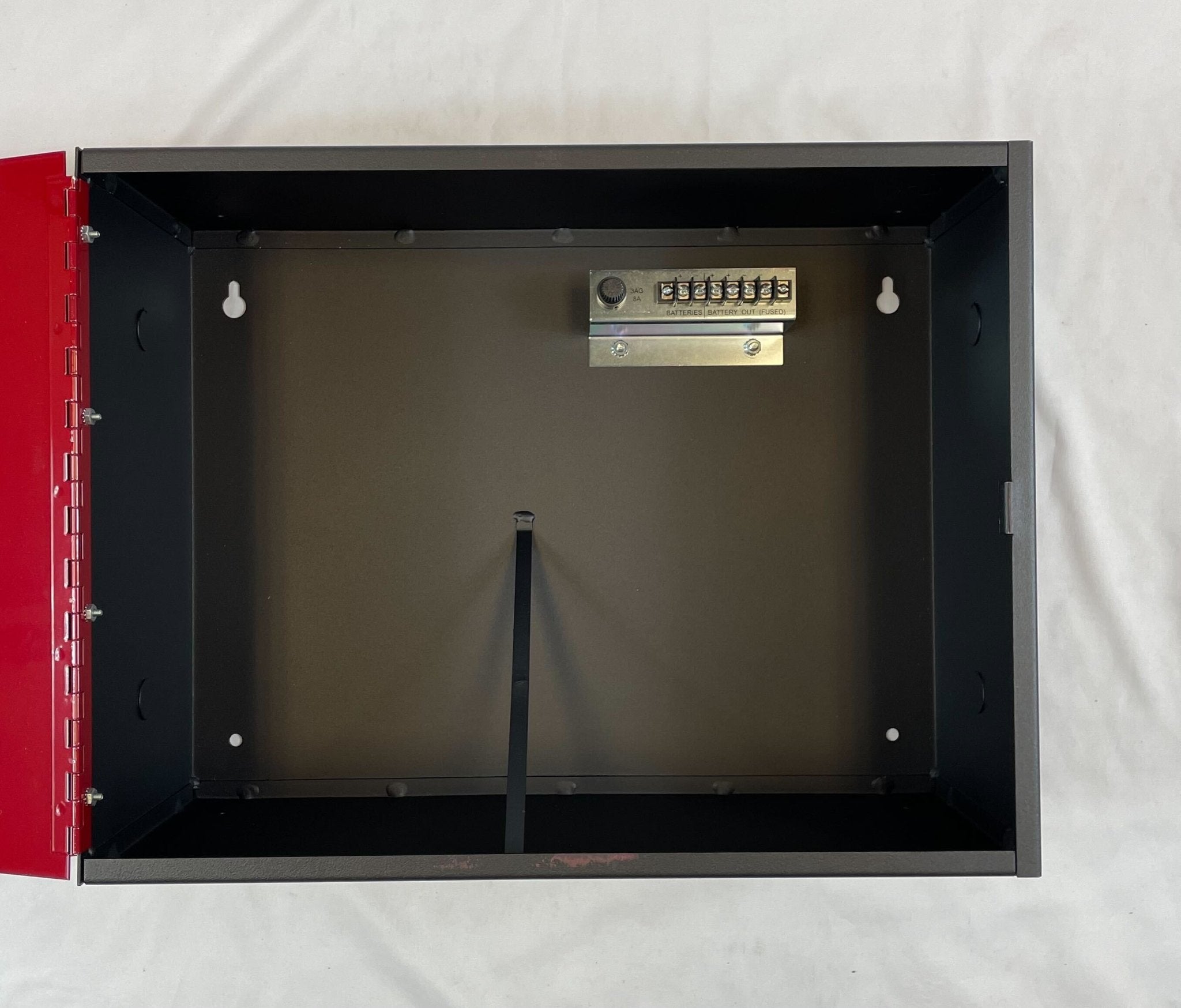 Edwards BC-1R backbox mounted on a wall, showcasing its sturdy metal construction and installation features.