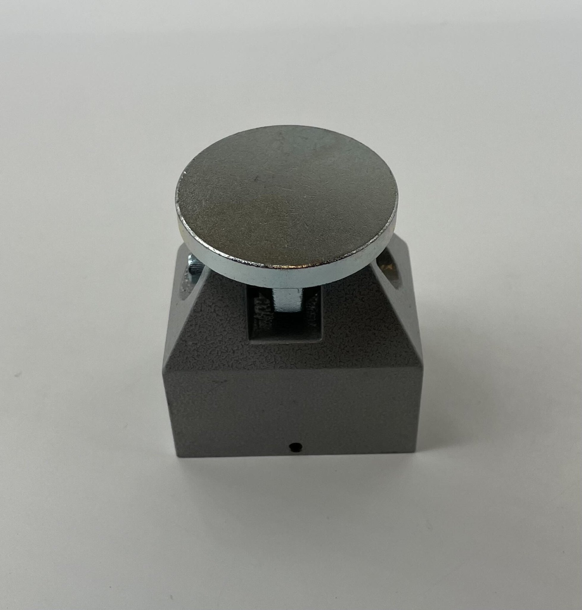 Edwards CS2598-5 door holder mounted on wall, made of metal, with a sleek finish, designed to securely hold doors open.