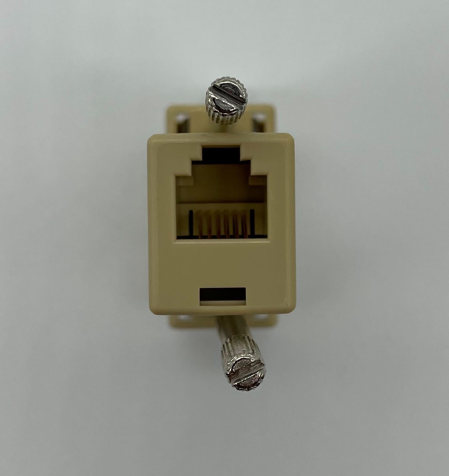 Edwards DB9/RJ11 fire alarm connector with metallic ports and black plastic casing, used for Edwards fire alarm systems.