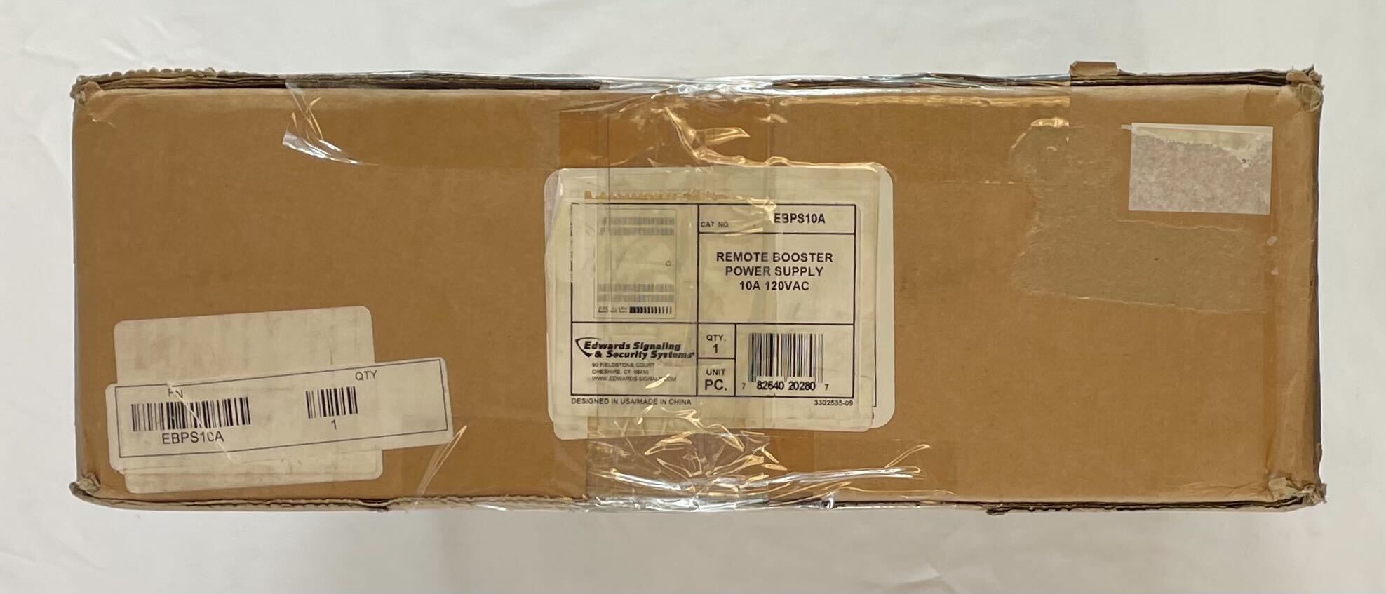 Edwards EBPS10A power supply unit with black and silver design, featuring input and output terminals, used in industrial applications