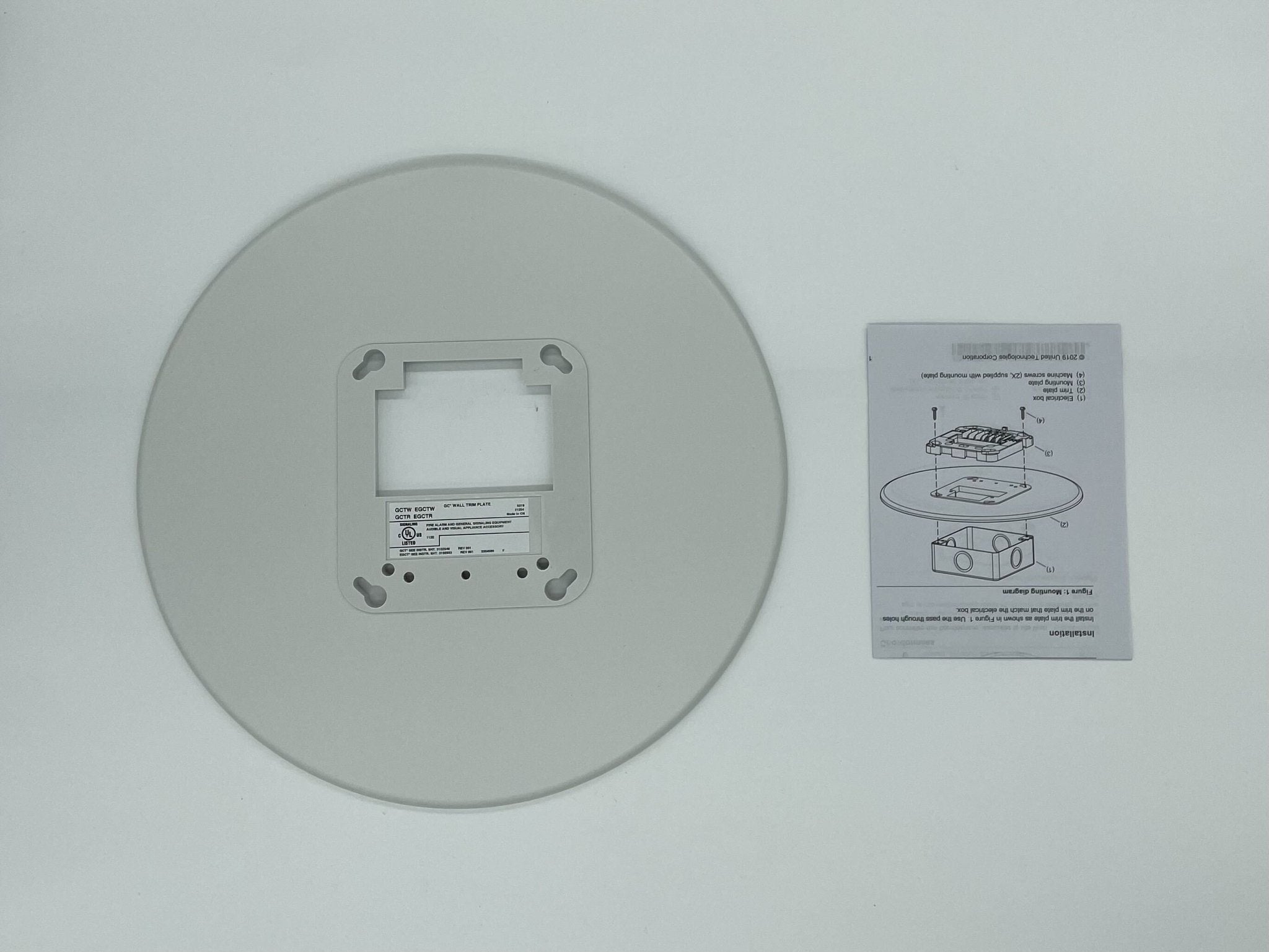 Edwards GCTW fire alarm with Jem Systems Canada label, featuring a white circular smoke detector with test and reset buttons.