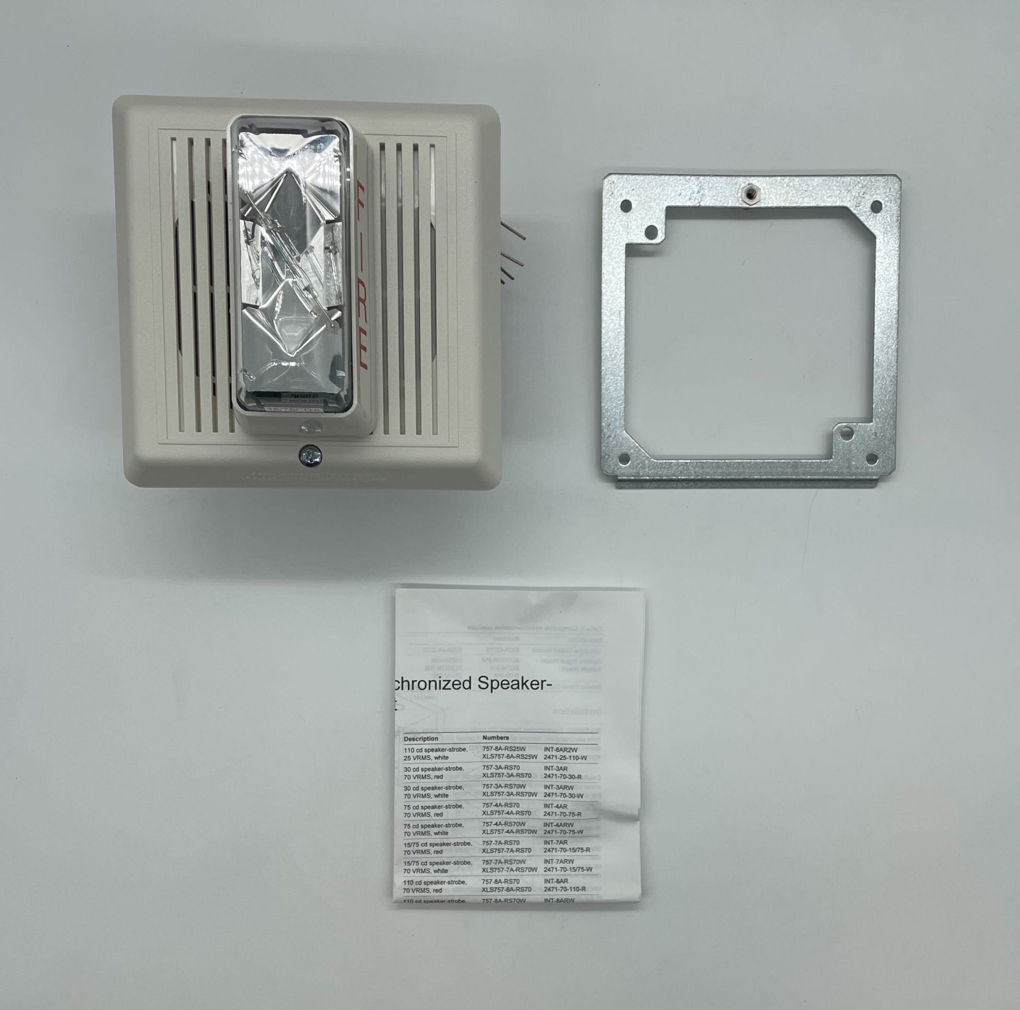 Edwards INT-7ARW speaker strobe alarm with white casing, mounted on wall for fire and emergency alert systems.