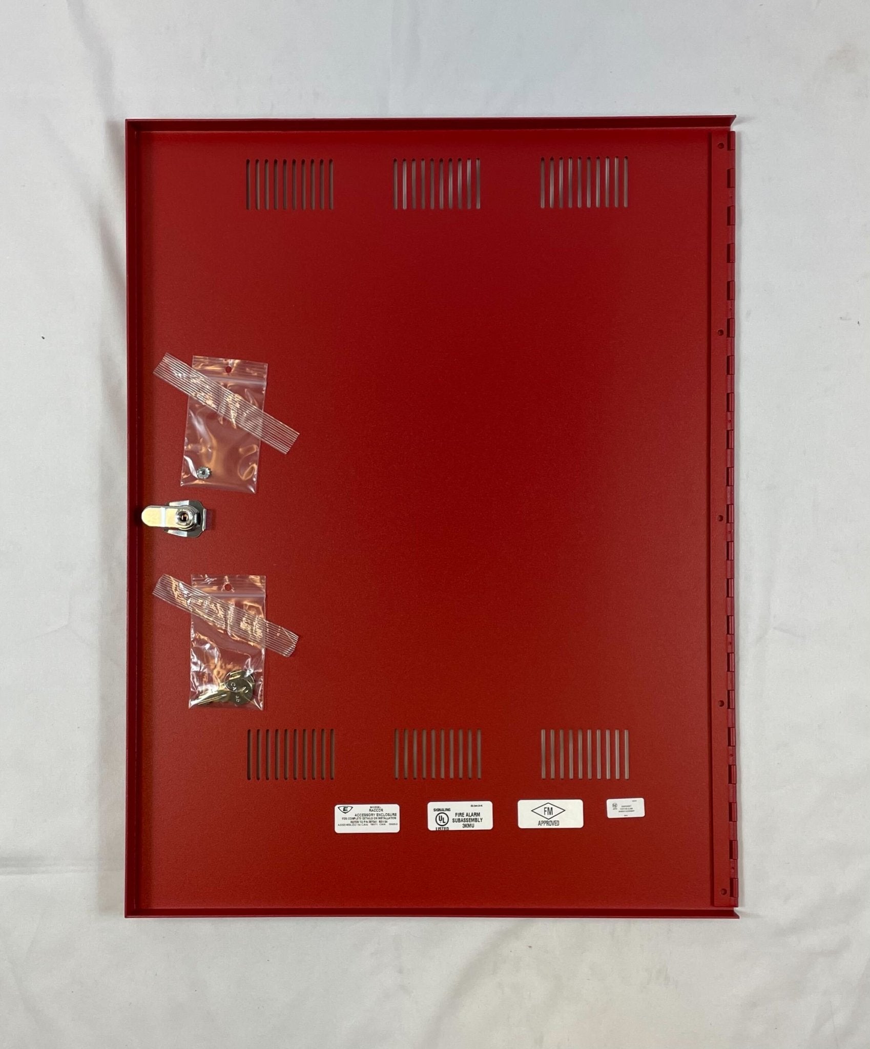 Edwards RACCDR fire alarm device mounted on wall, part of Edwards fire alarm systems, with a white rectangular design.
