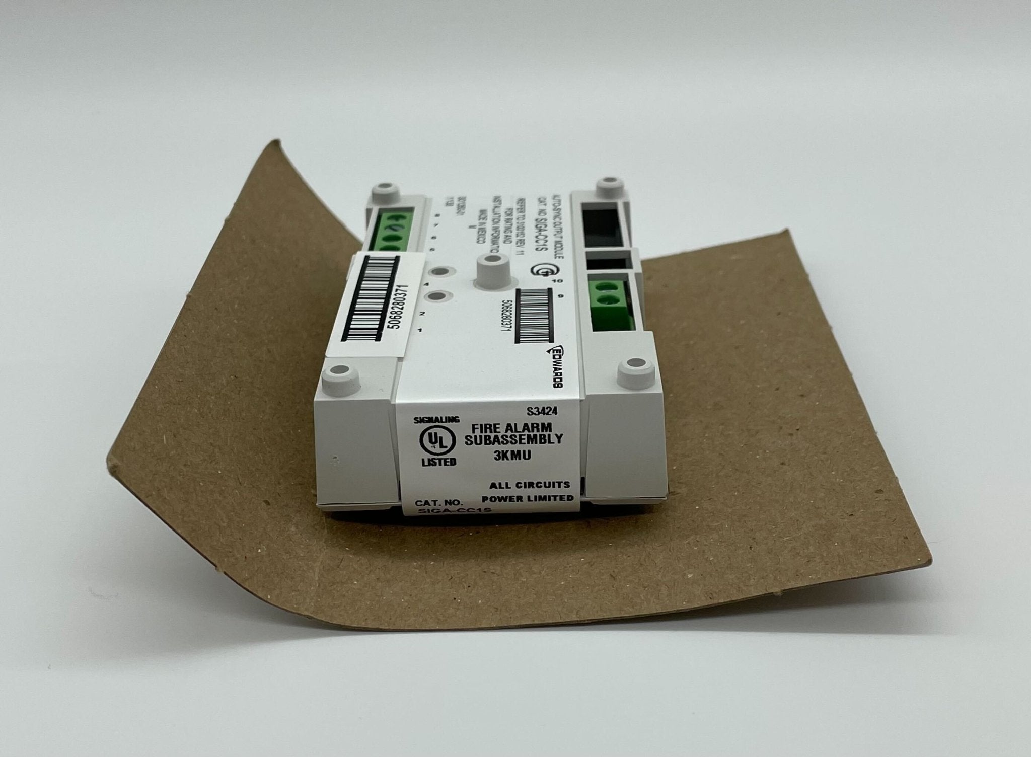 Edwards SIGA-CC1S Synchronization Output Module installed in a control panel, showing connectors and electronic components.