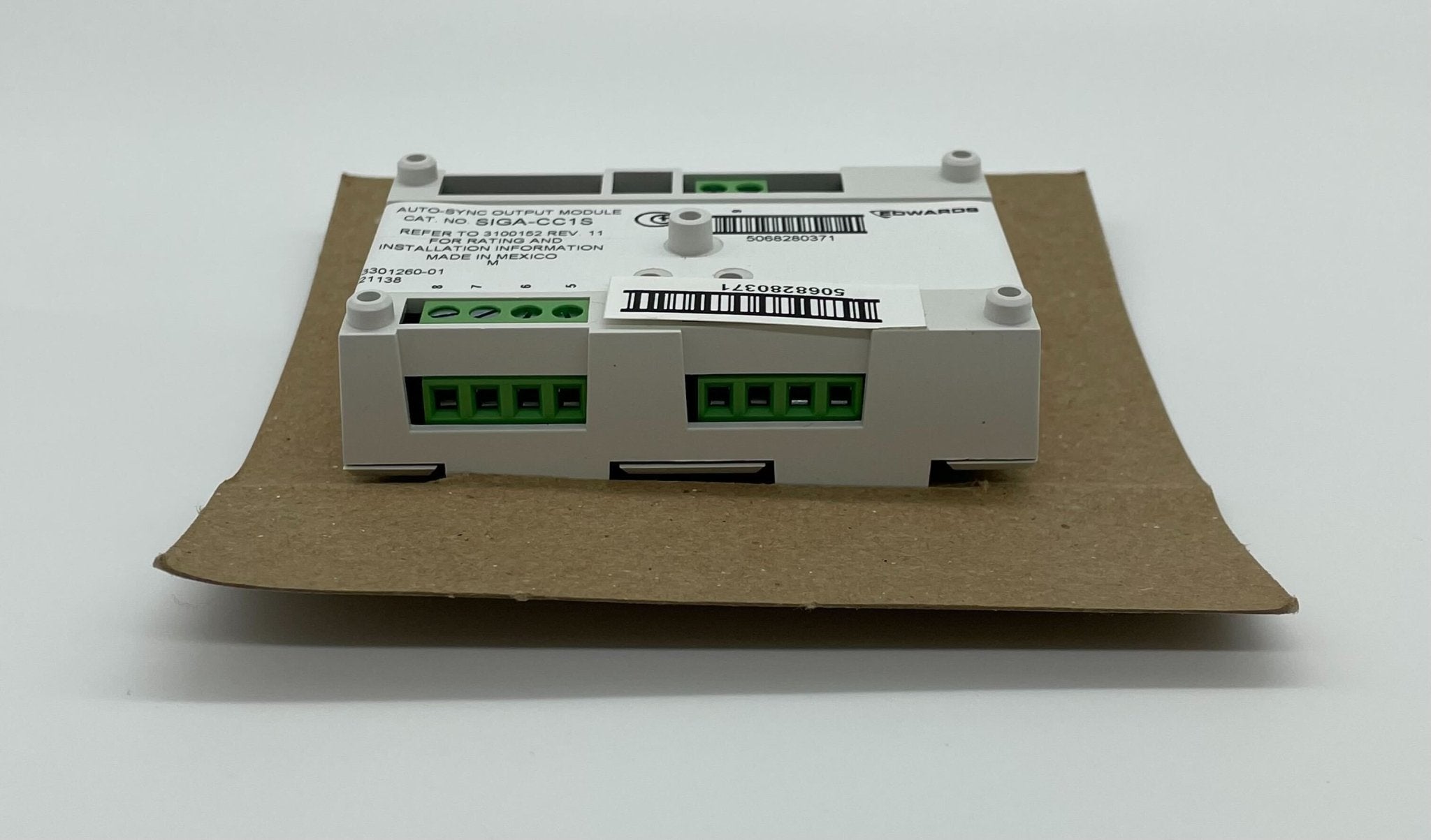 Edwards SIGA-CC1S Synchronization Output Module, a compact black electronic module with connection ports for system integration.