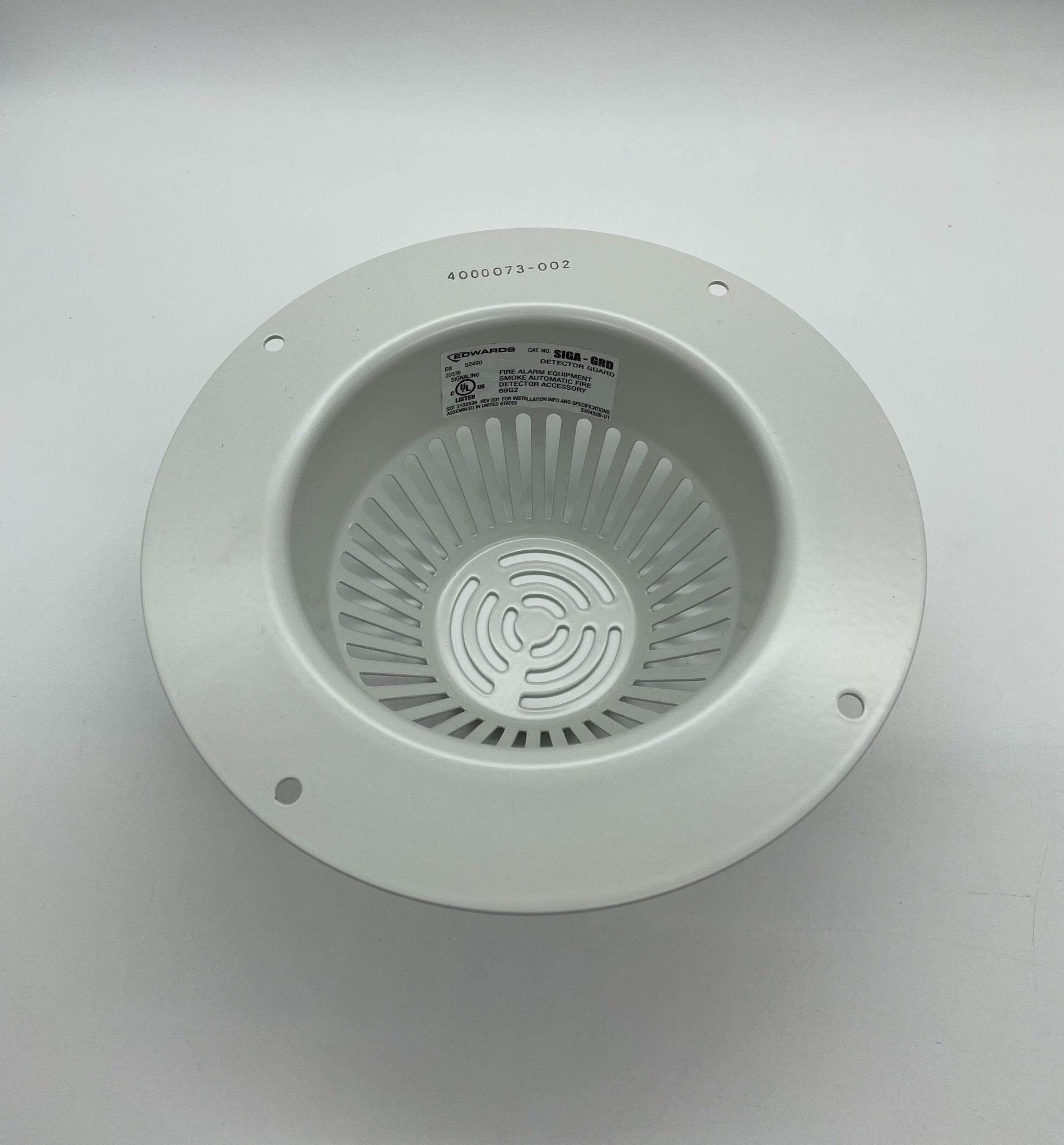 Edwards SIGA-GRD smoke detector mounted on ceiling, black and white design, part of Edwards smoke detection system.