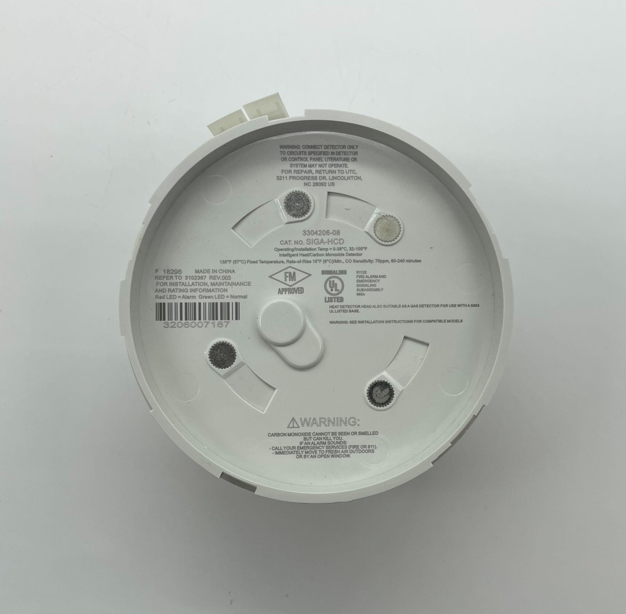Edwards SIGA-HCD heat detector mounted on ceiling, part of Edwards fire safety system, with wiring and mounting bracket visible.