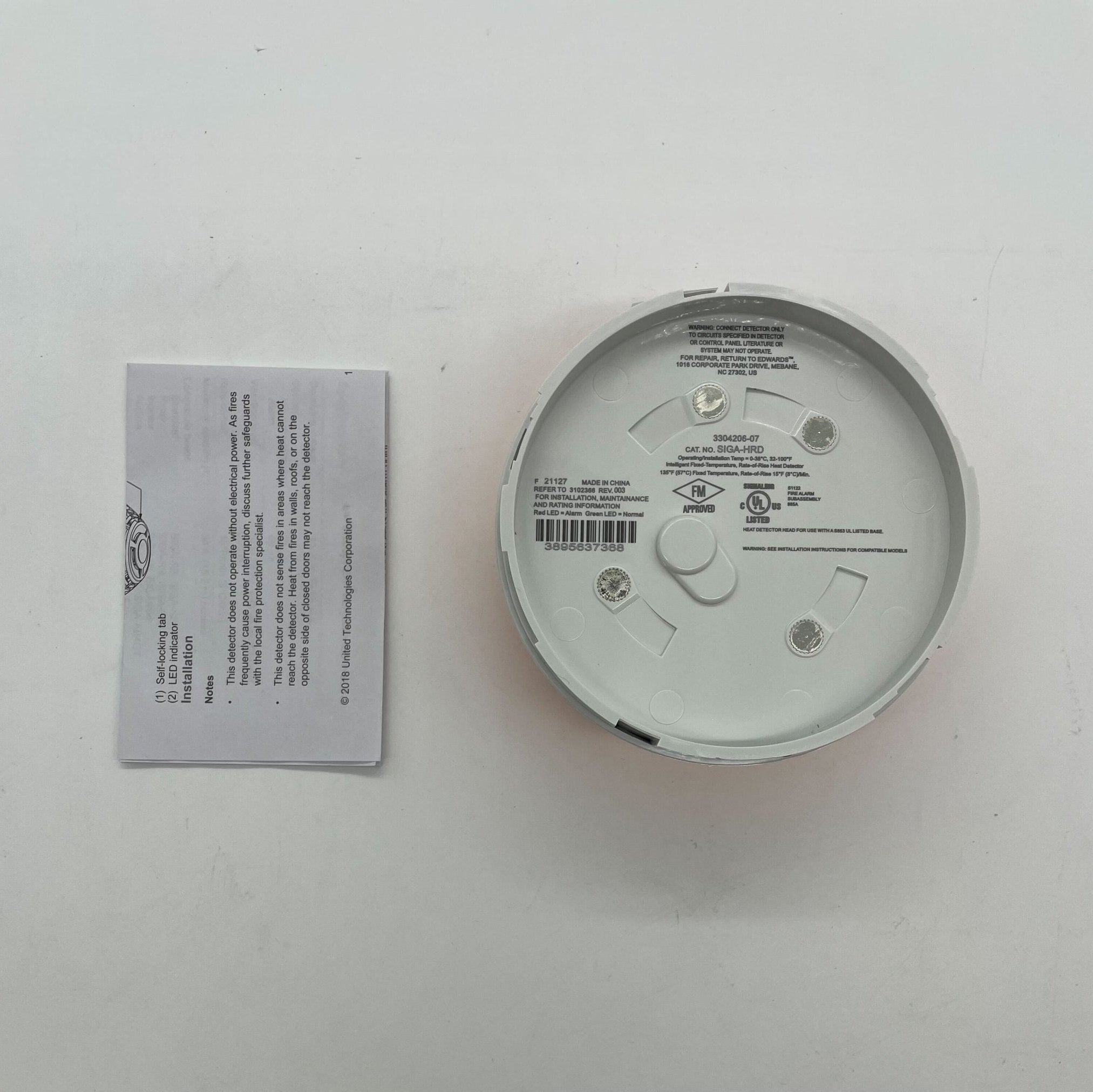 Edwards SIGA-HRD Intelligent Heat Detector installed on ceiling, part of fire safety system, by Edwards.