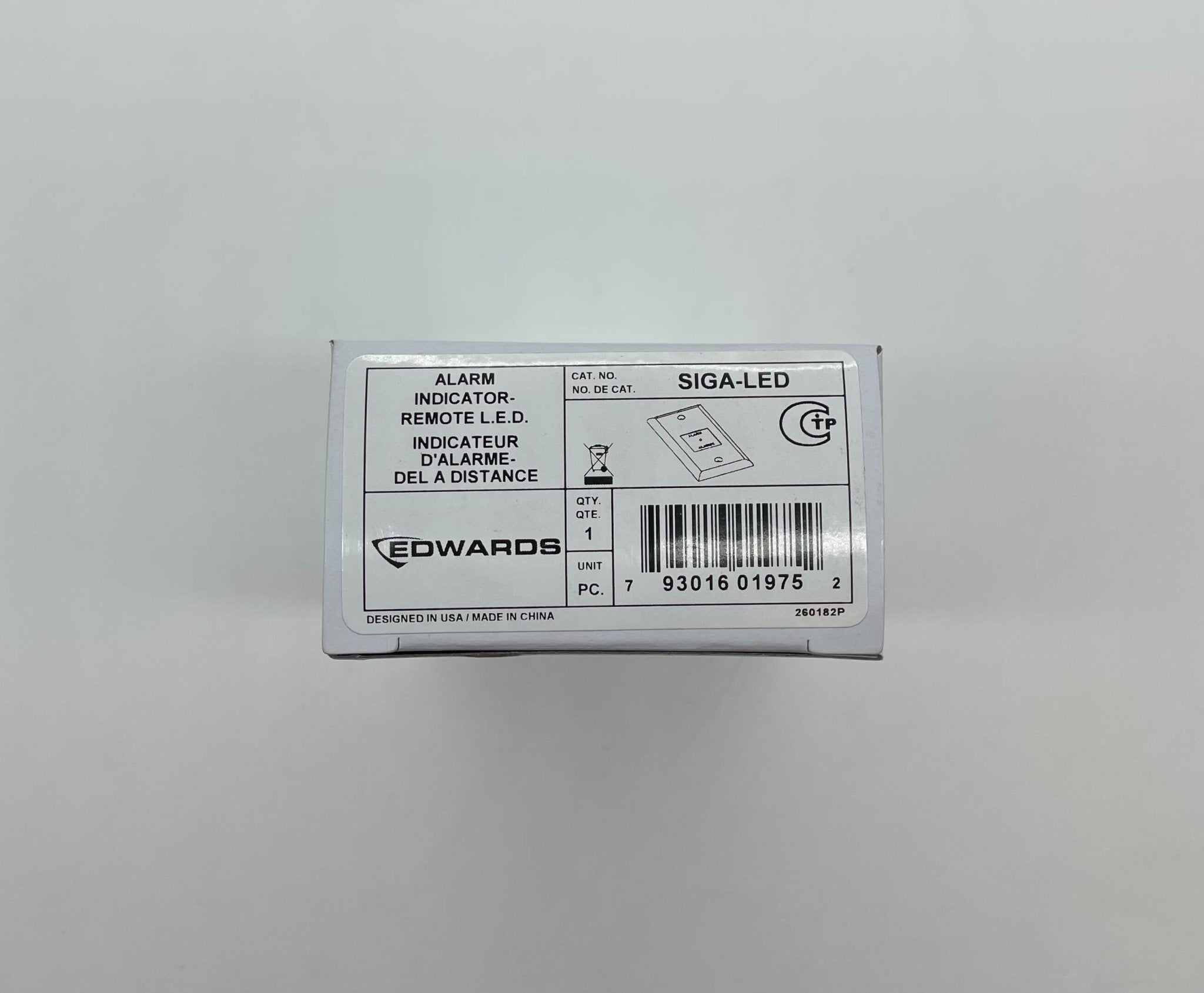 Edwards SIGA-LED fire alarm with LED indicator light, mounted on ceiling, featuring sleek white design and safety label.