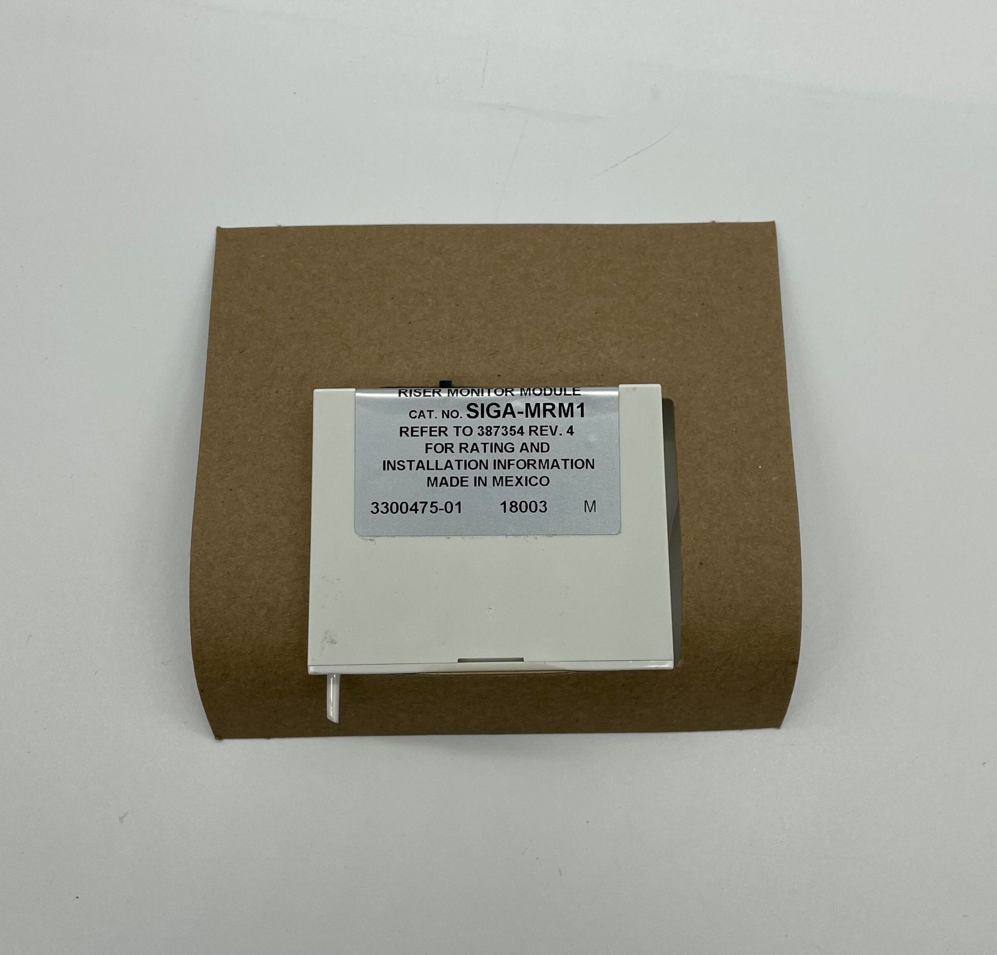 Edwards SIGA-MRM1 module for Jem Systems Canada, showing a compact industrial control module with connectors and electronic components.
