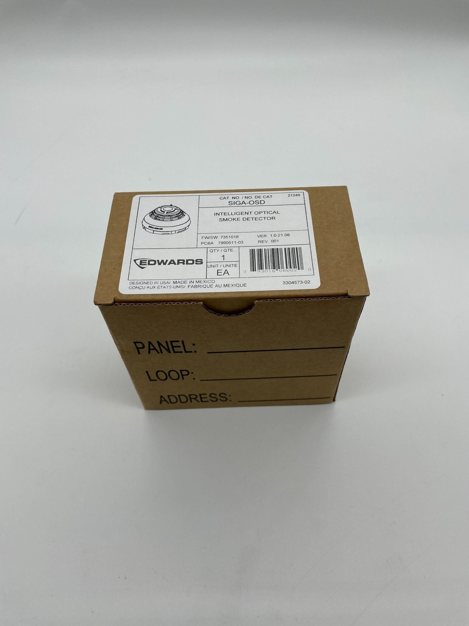 Edwards SIGA-OSD smoke detector mounted on ceiling, black and white sensor device for fire safety detection