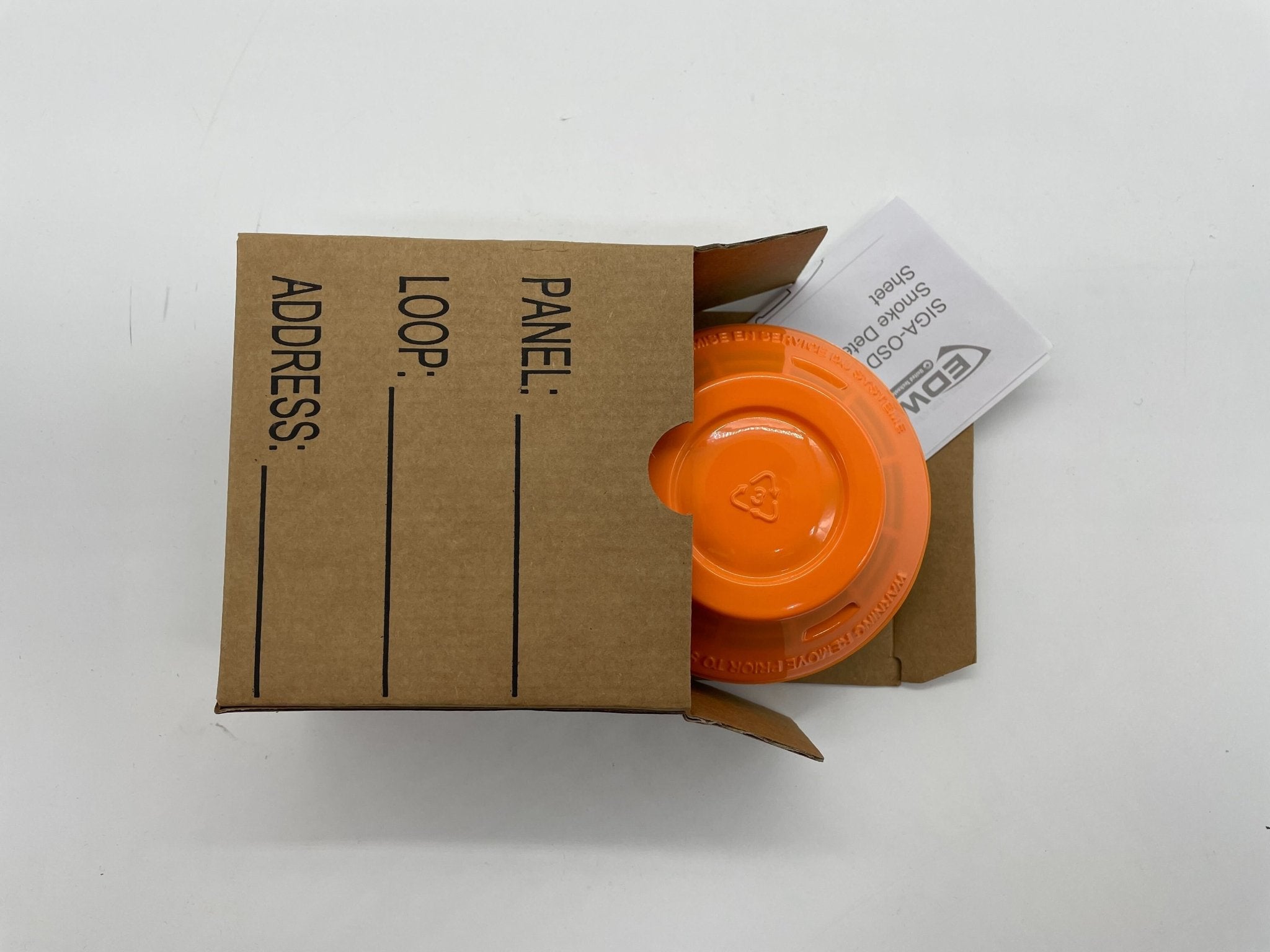 Edwards SIGA-OSD smoke detector mounted on ceiling, black and white sensor with wiring, for fire safety in buildings