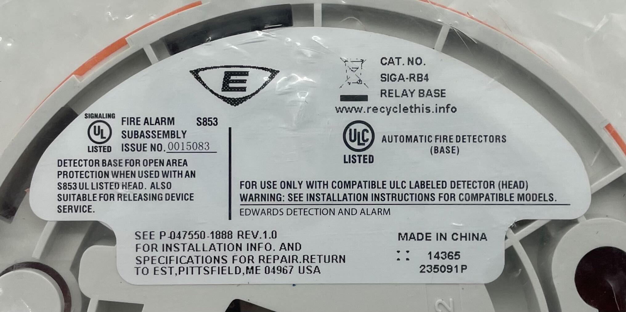 Edwards SIGA-RB4 base for Jem Systems, shown in a technical setting with components and equipment in the background.