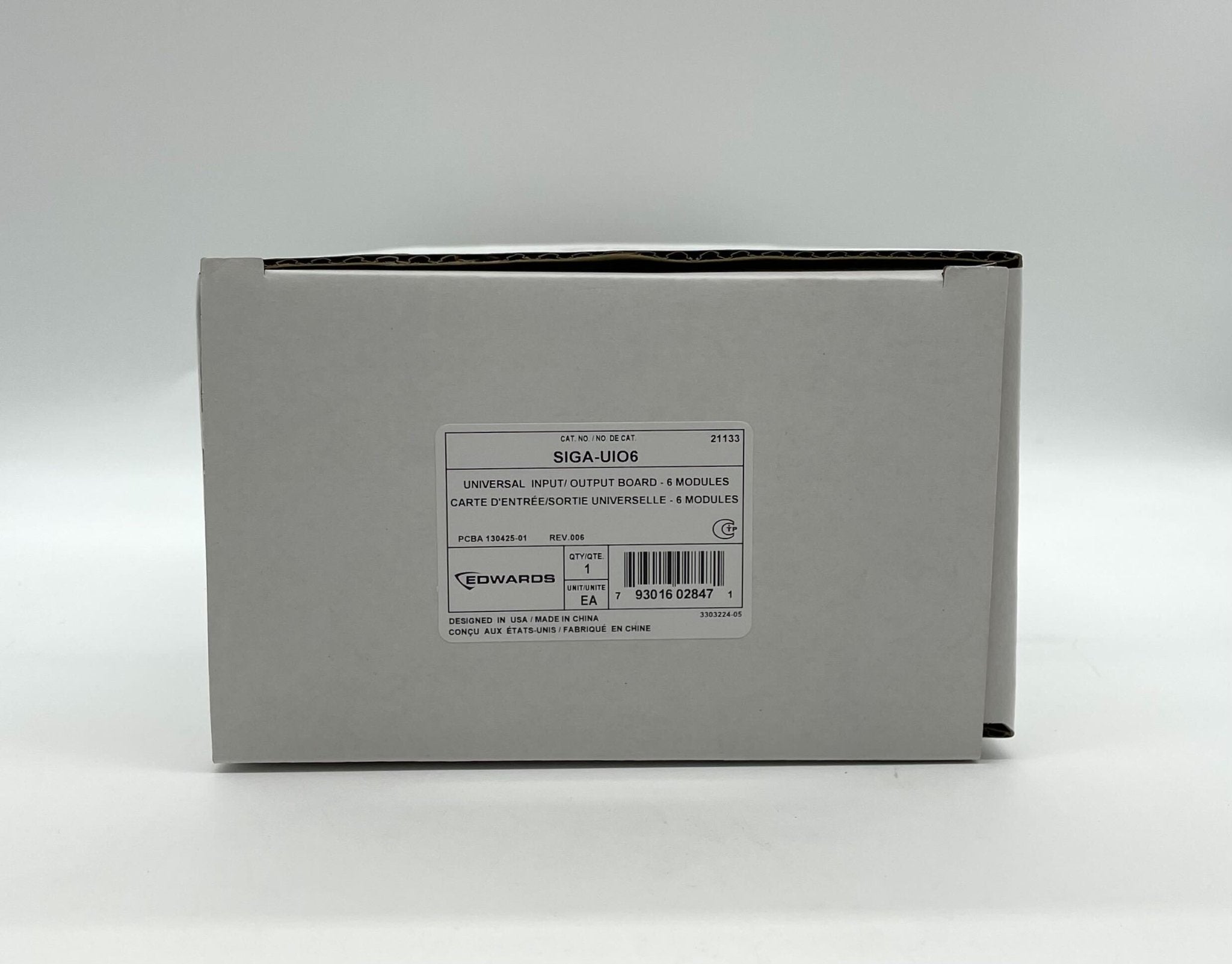 Edwards SIGA-UIO6 modules for industrial systems, shown in a professional technical setting with wiring and components.