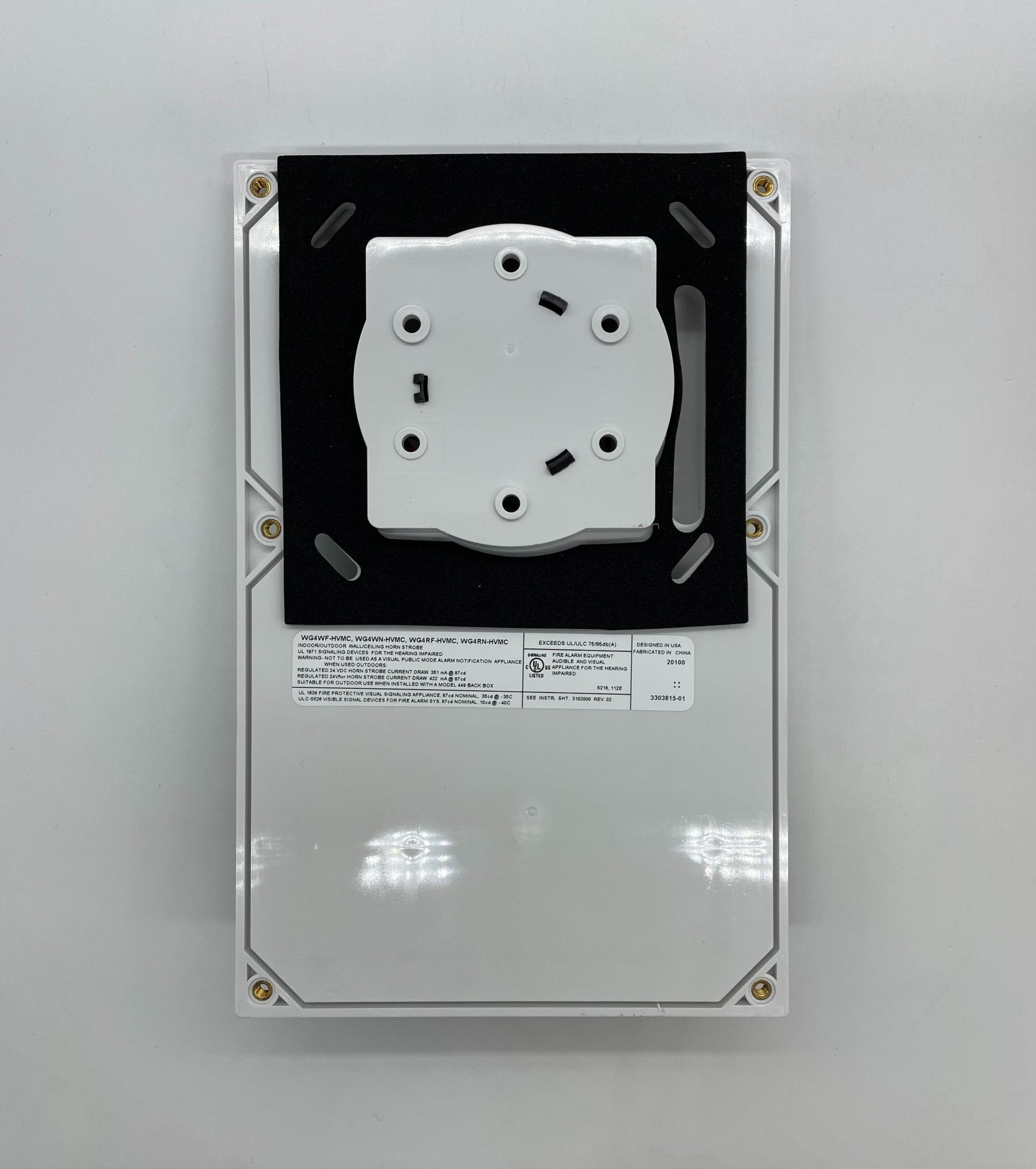 Edwards WG4RF-HVMC horn strobe alarm device mounted on wall, with visible speaker and flashing strobe light for emergency alerts.