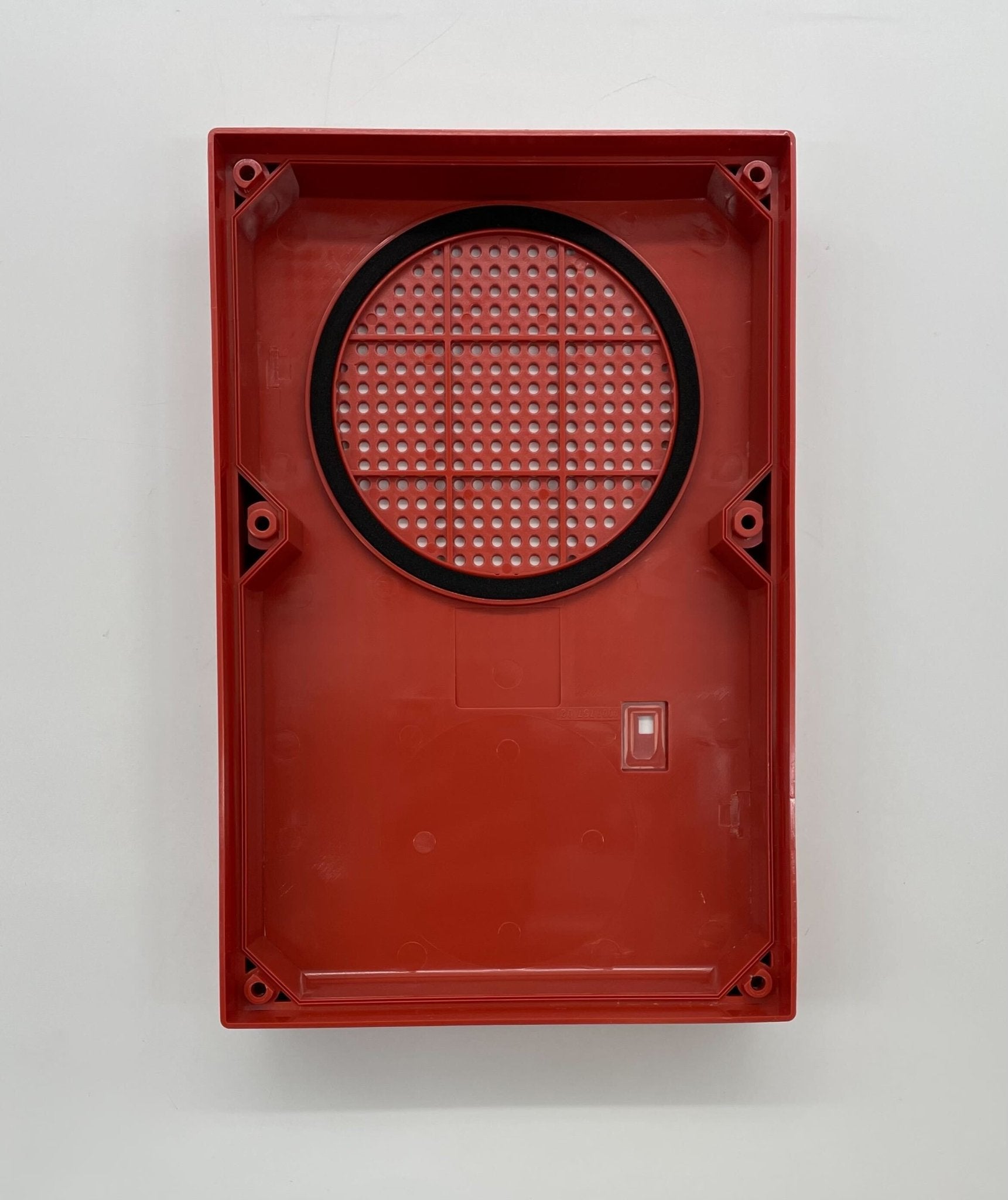 Edwards WG4RN-S speaker strobe with white housing and red lens, mounted on wall for fire alarm notification.