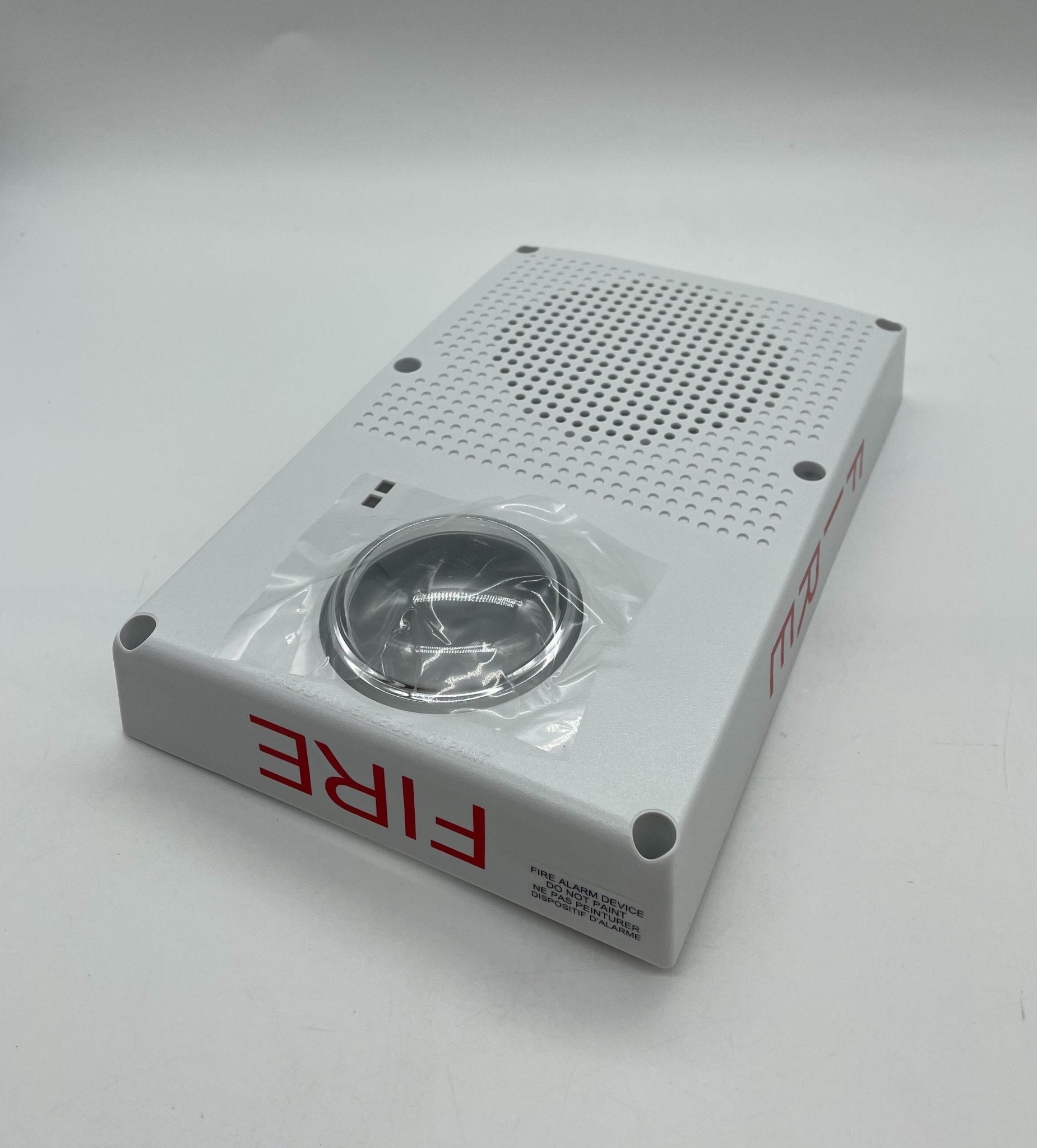 Edwards WG4WF-SVMHC speaker strobe with white housing and audible alert, mounted on wall for fire and safety signaling.