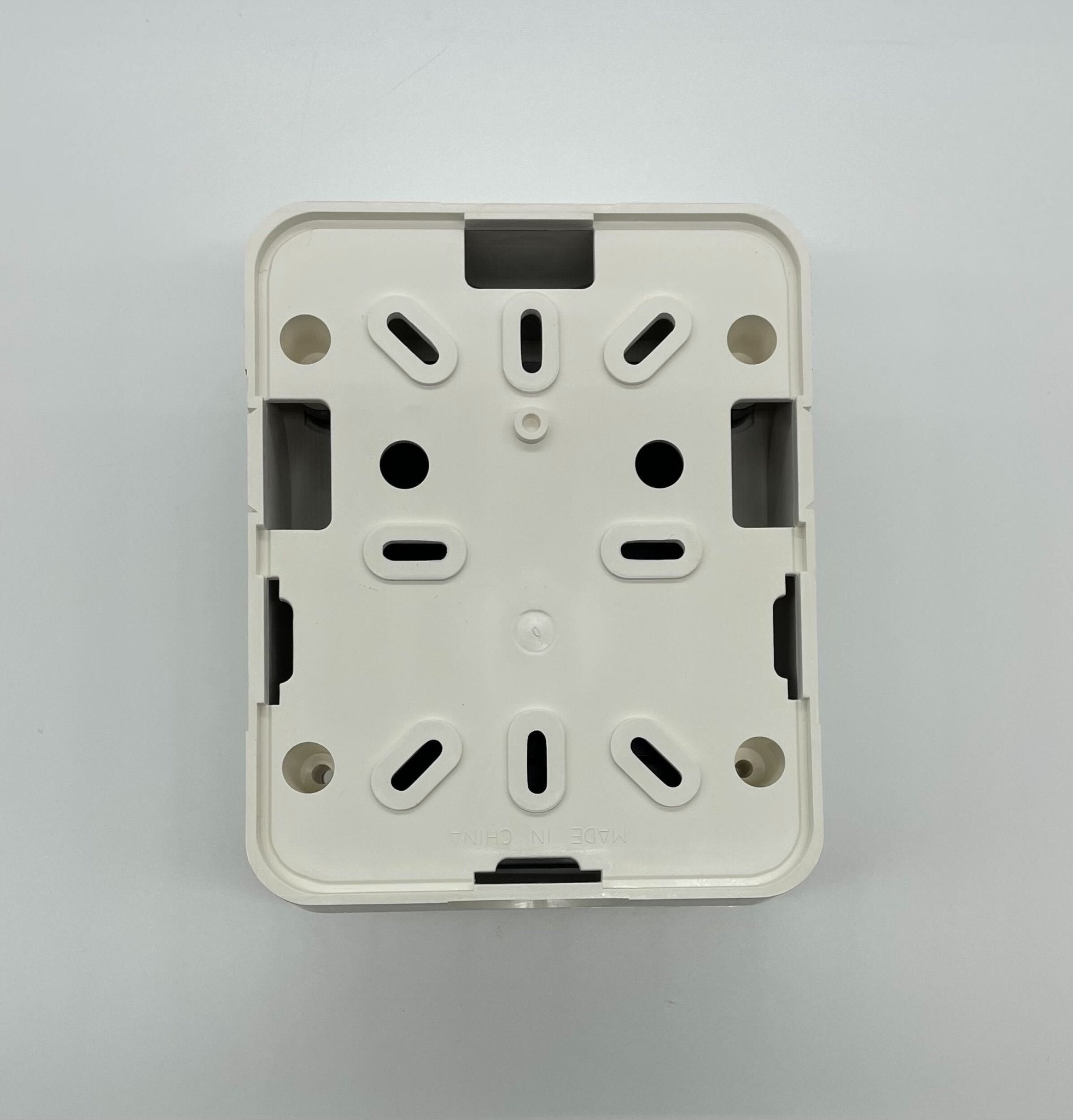 Gentex AVSM-W synchronization control module in white, designed for vehicle lighting systems, shown in the image.