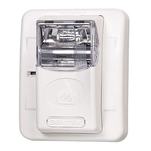 Gentex GES24-177WW fire alarm with white cover, mounted on wall, showcasing its compact design and brand label.