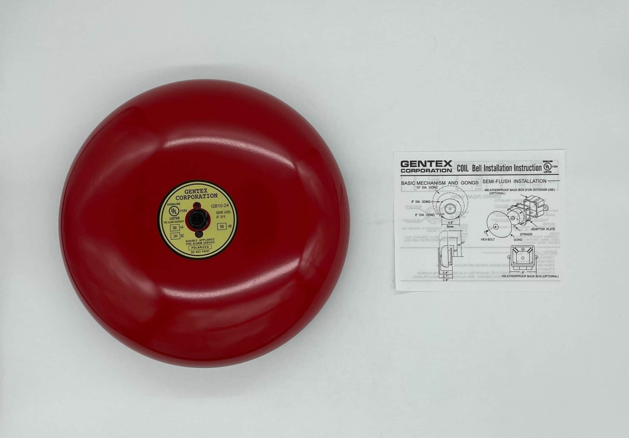 Gentex GB10-24 10-inch fire alarm bell mounted on wall, black metal bell with mounting bracket, for fire alarm systems.