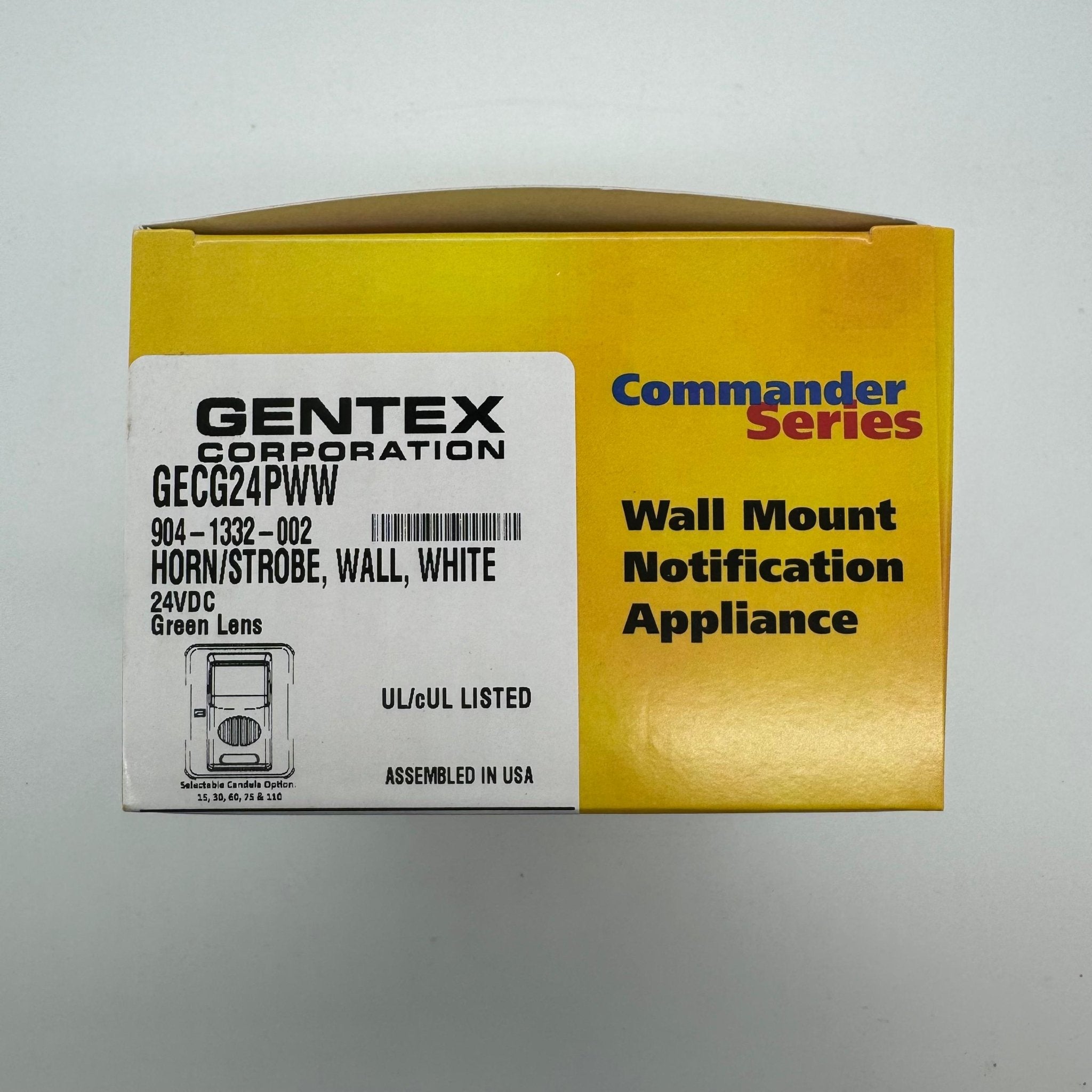 Gentex GECG24PWW fire alarm horn strobe with green lens, mounted on wall, for emergency signaling in safety systems