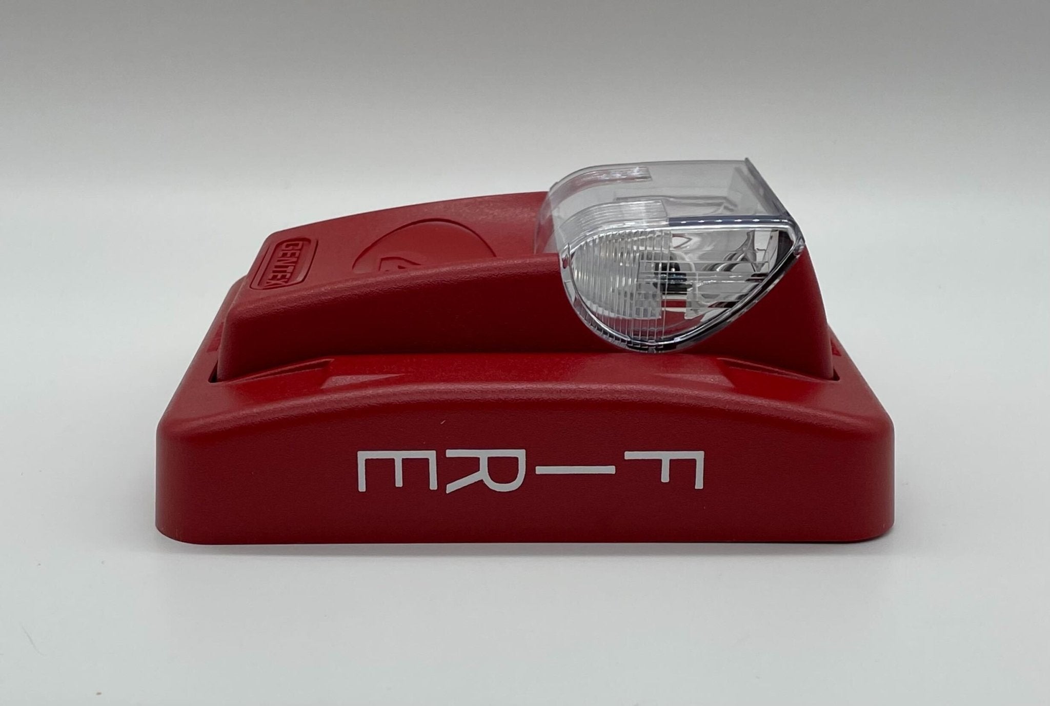 Gentex GES3-12WR strobe light with red lens, mounted on a ceiling, designed for emergency warning systems.