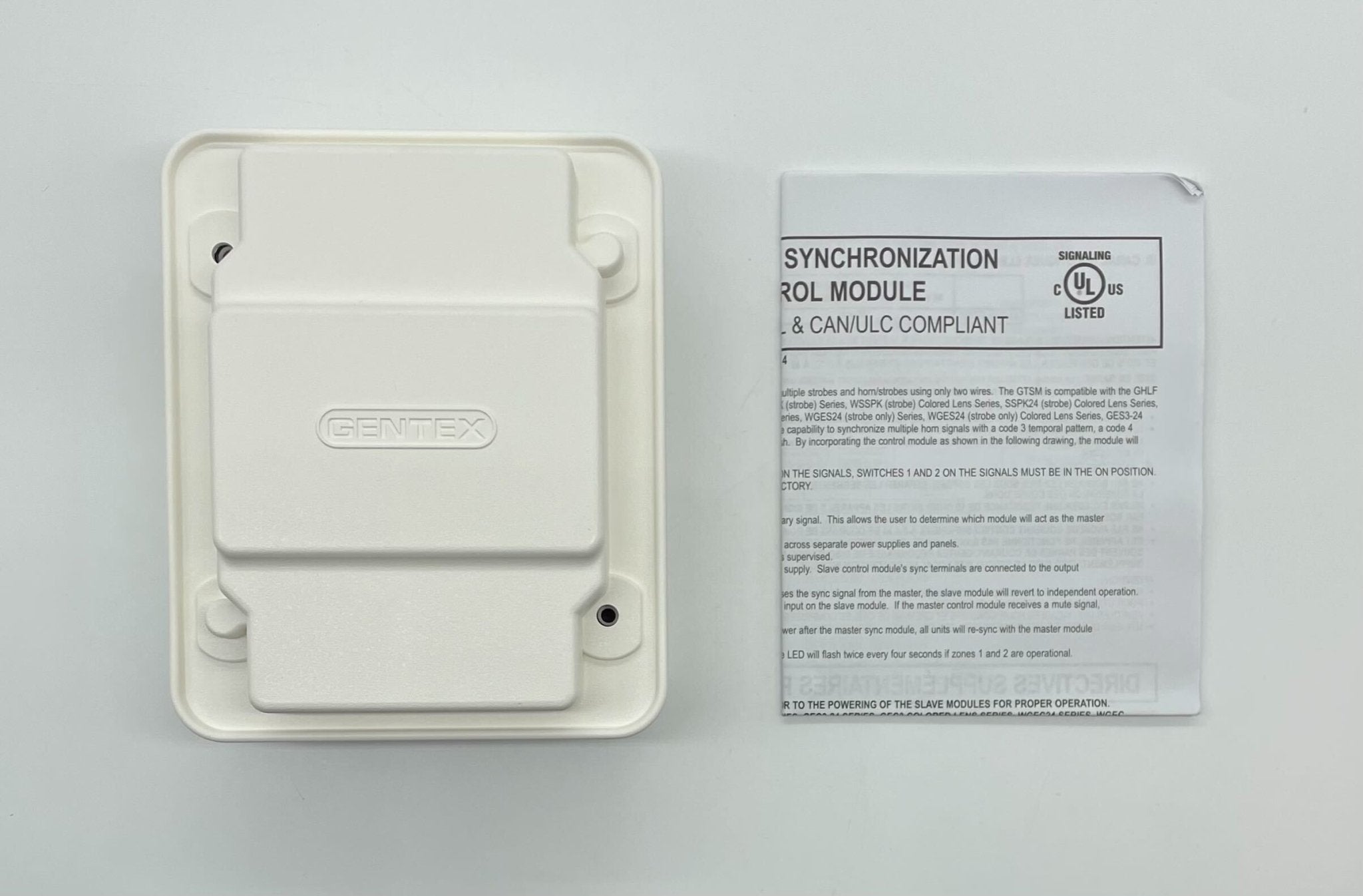 Gentex GTSM-W gangable synchronization module for security systems, shown mounted on a panel with wiring visible.